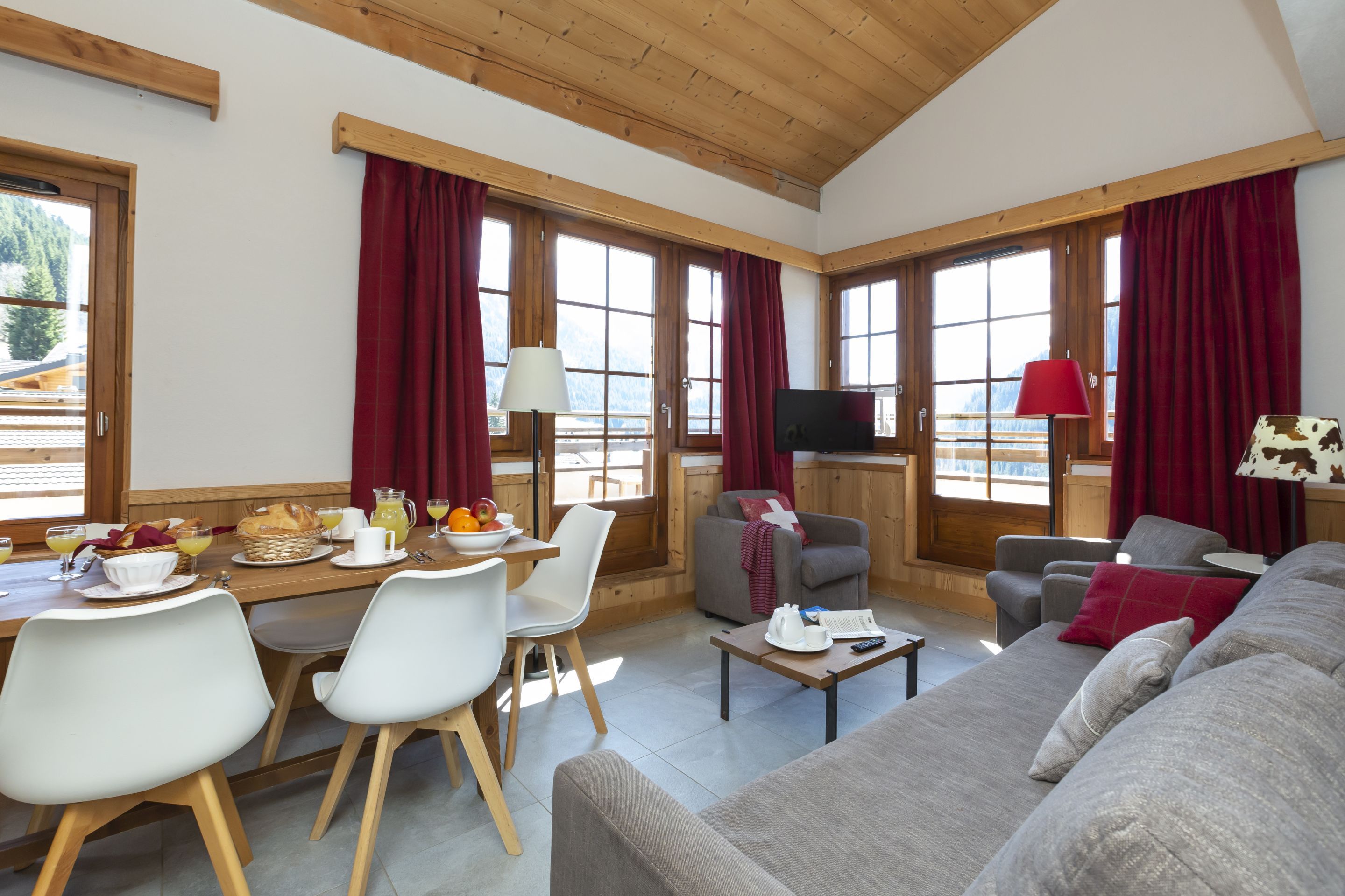 image The living area's sloped timber ceiling and generous windows give the apartment a proper Alpine chalet feel.