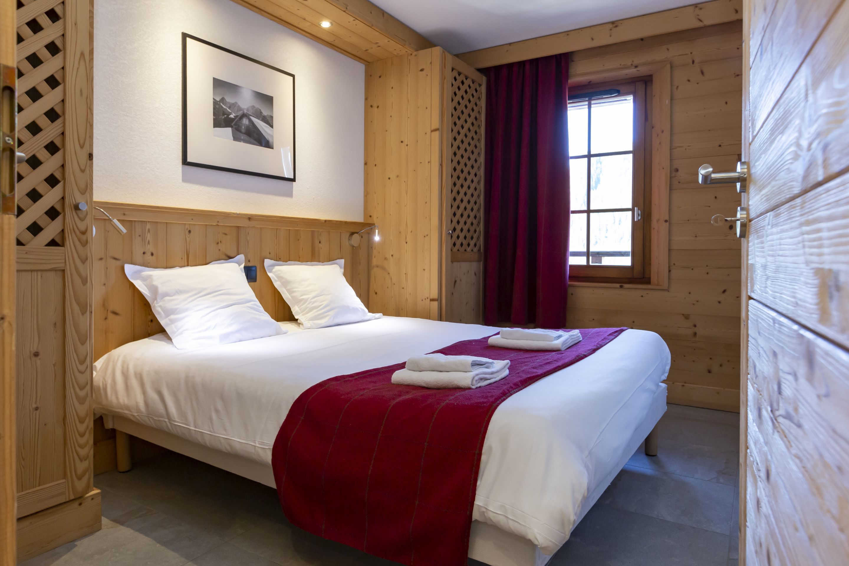image The double bedroom with white linens made up on arrival and wall-mounted reading lights for a proper night's rest.