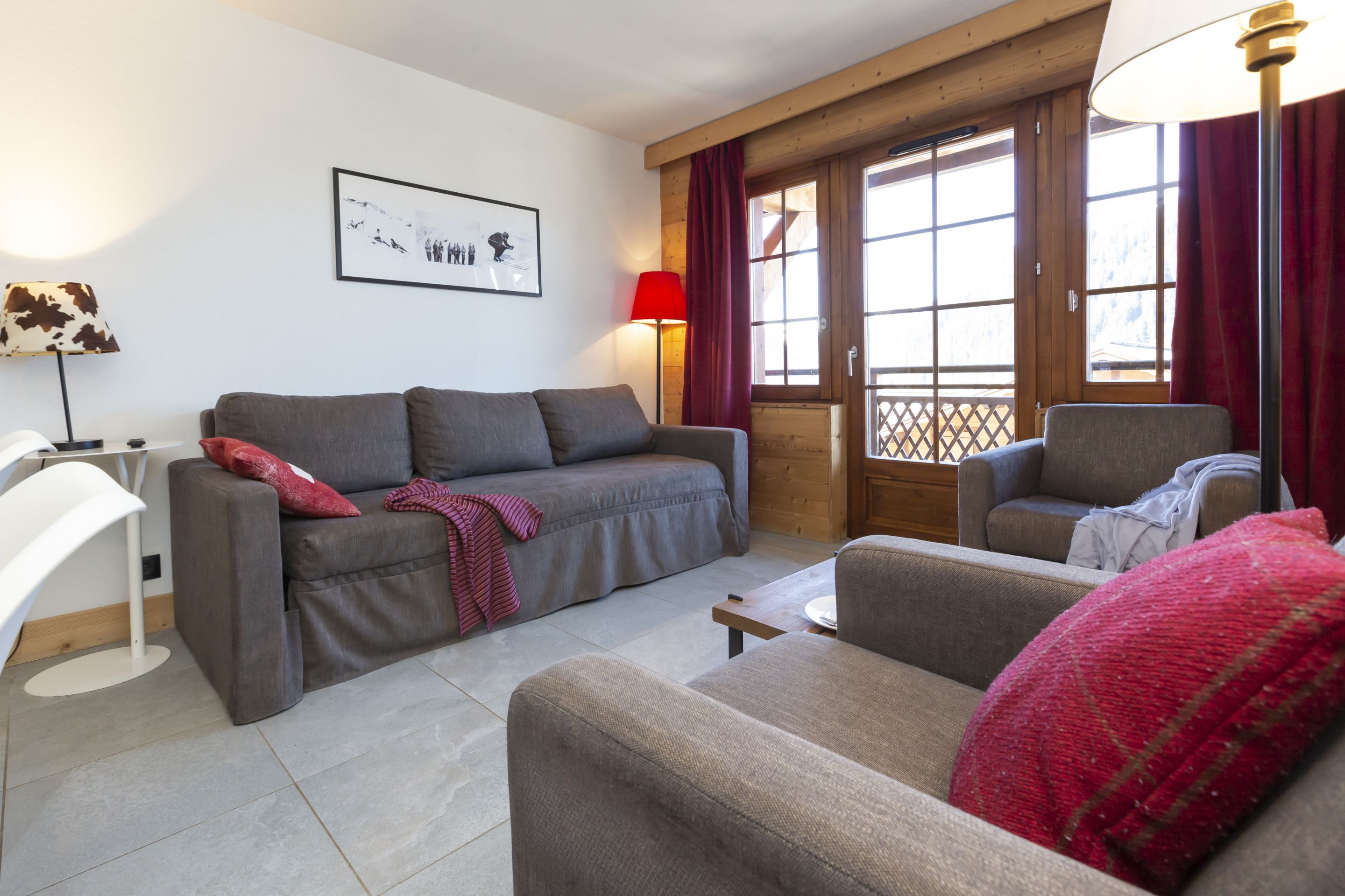 image The living room's warm timber panelling and generous windows set a relaxed tone for evenings back from the Portes du Soleil.