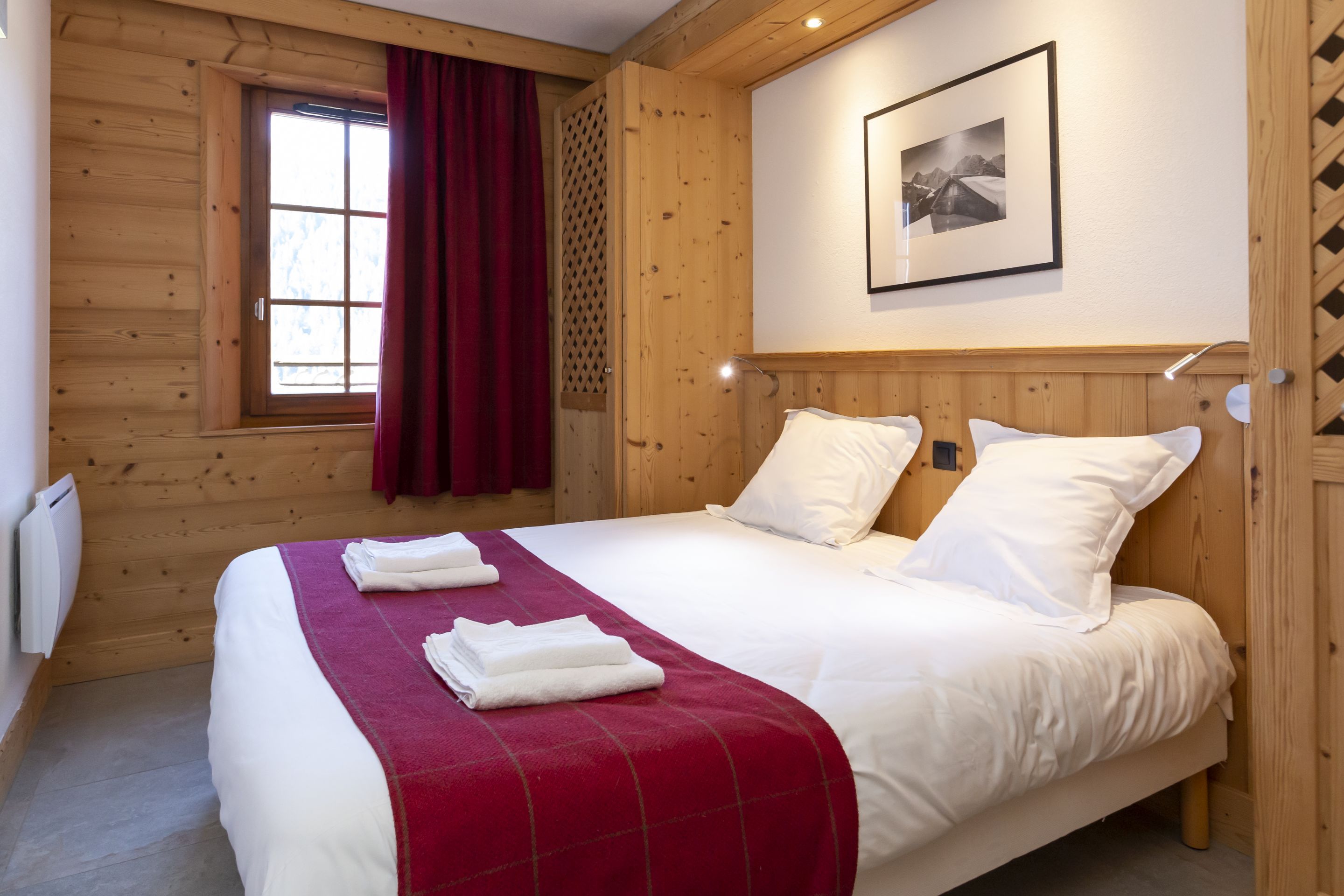 image The double bedroom with warm linens made up on arrival — a proper rest ahead of another day on the Portes du Soleil's 316 pistes.