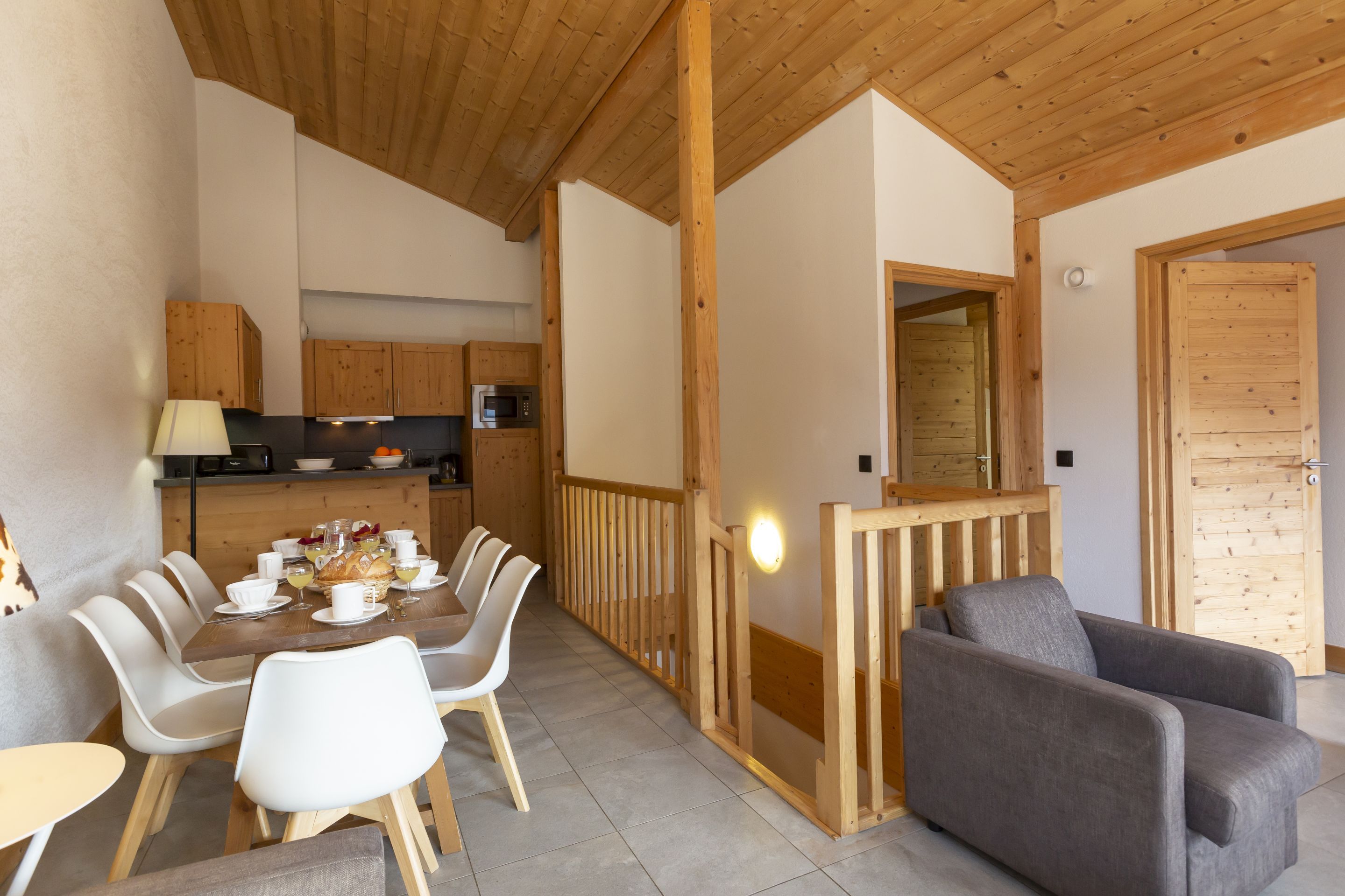 image The kitchen and dining area flow together in an open layout, with the staircase to the upper level just beyond.