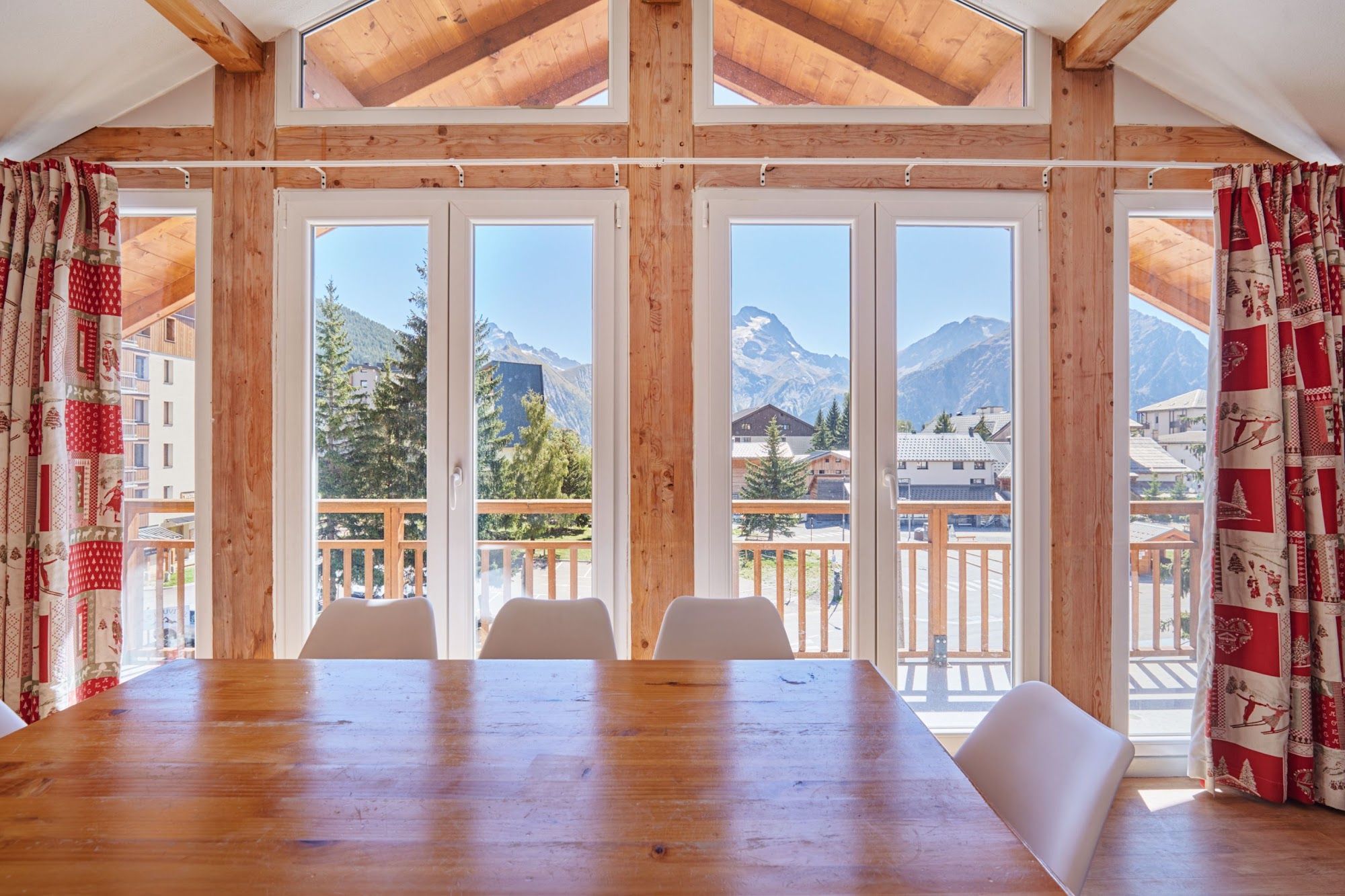 image Dining table beside large windows with a mountain view