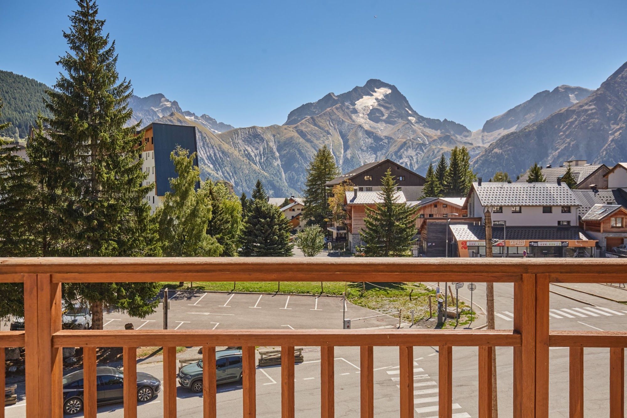 image Balcony view of mountains and nearby buildings among trees