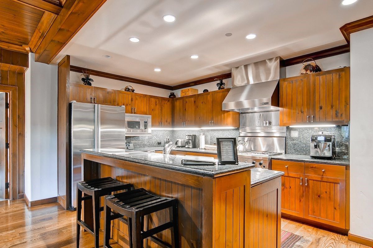 image Granite countertops and updated appliances give a luxurious feel to the kitchen.