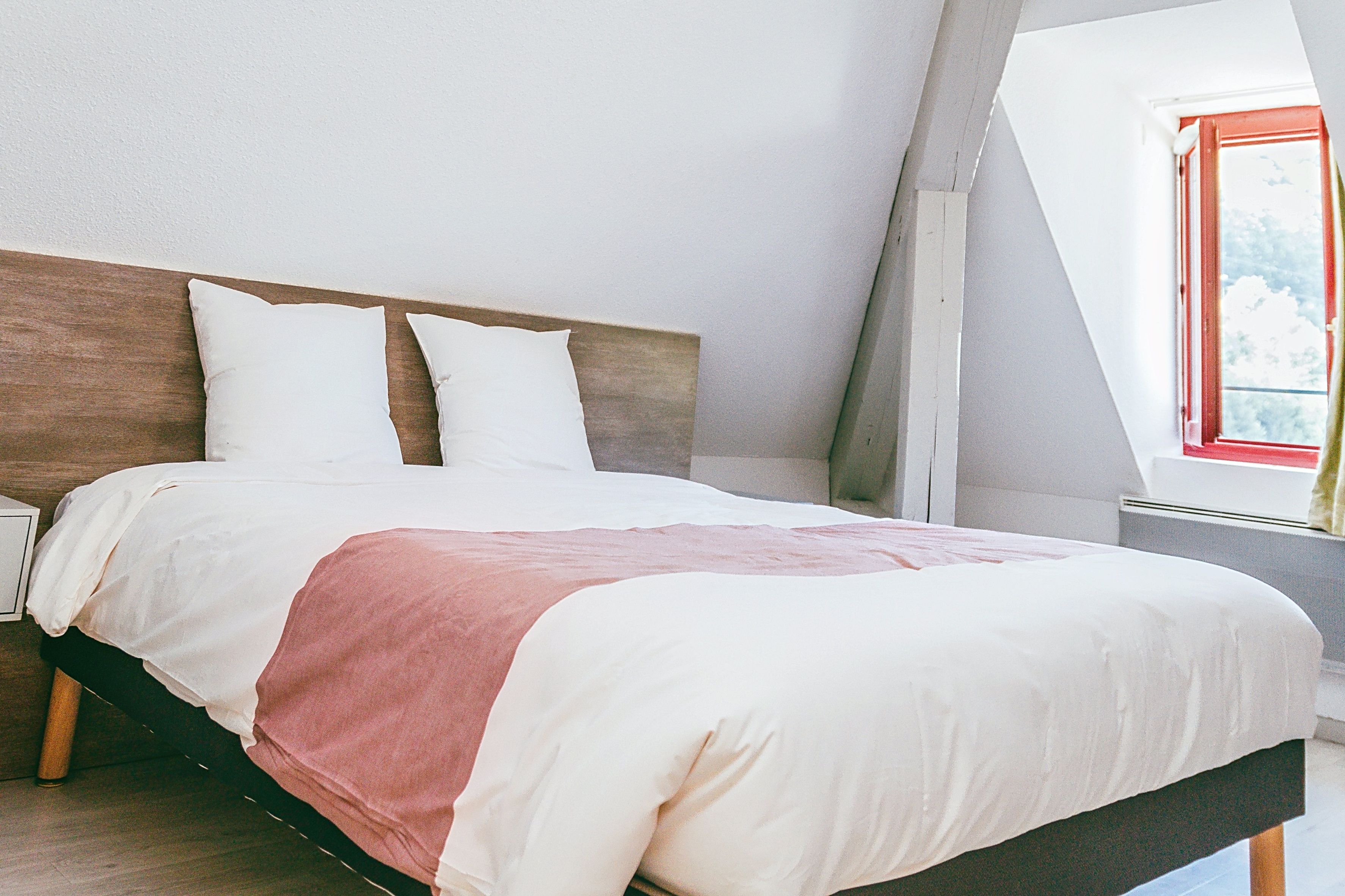 image Bedroom with a double bed under a slanted roof.