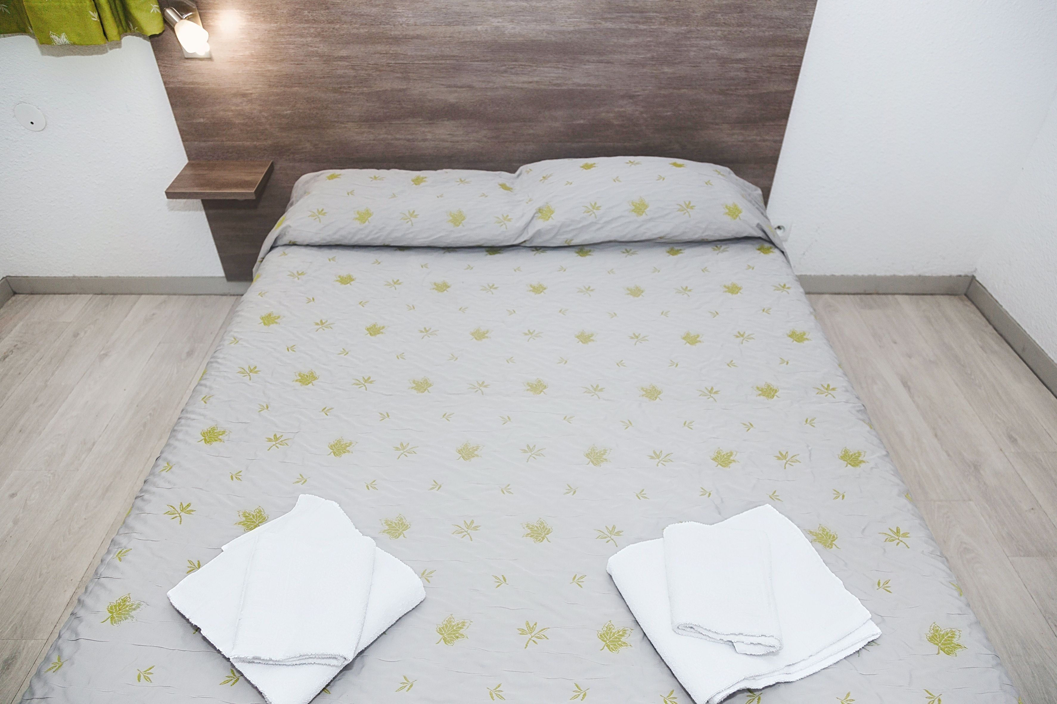 image Bedroom with a double bed and neatly folded towels.