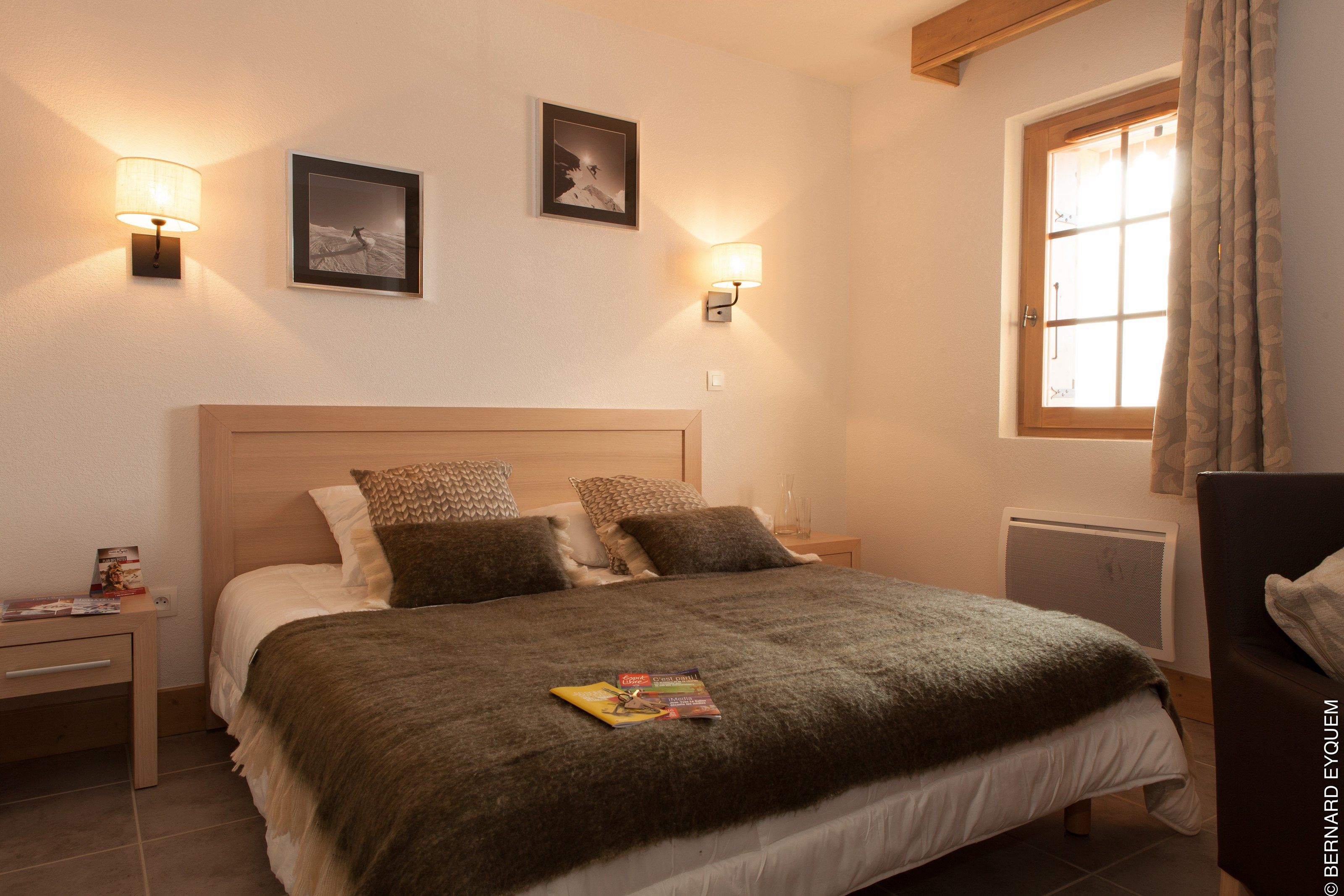 image The master bedroom features a lovely wood touches - decorated in the classic chalet style.