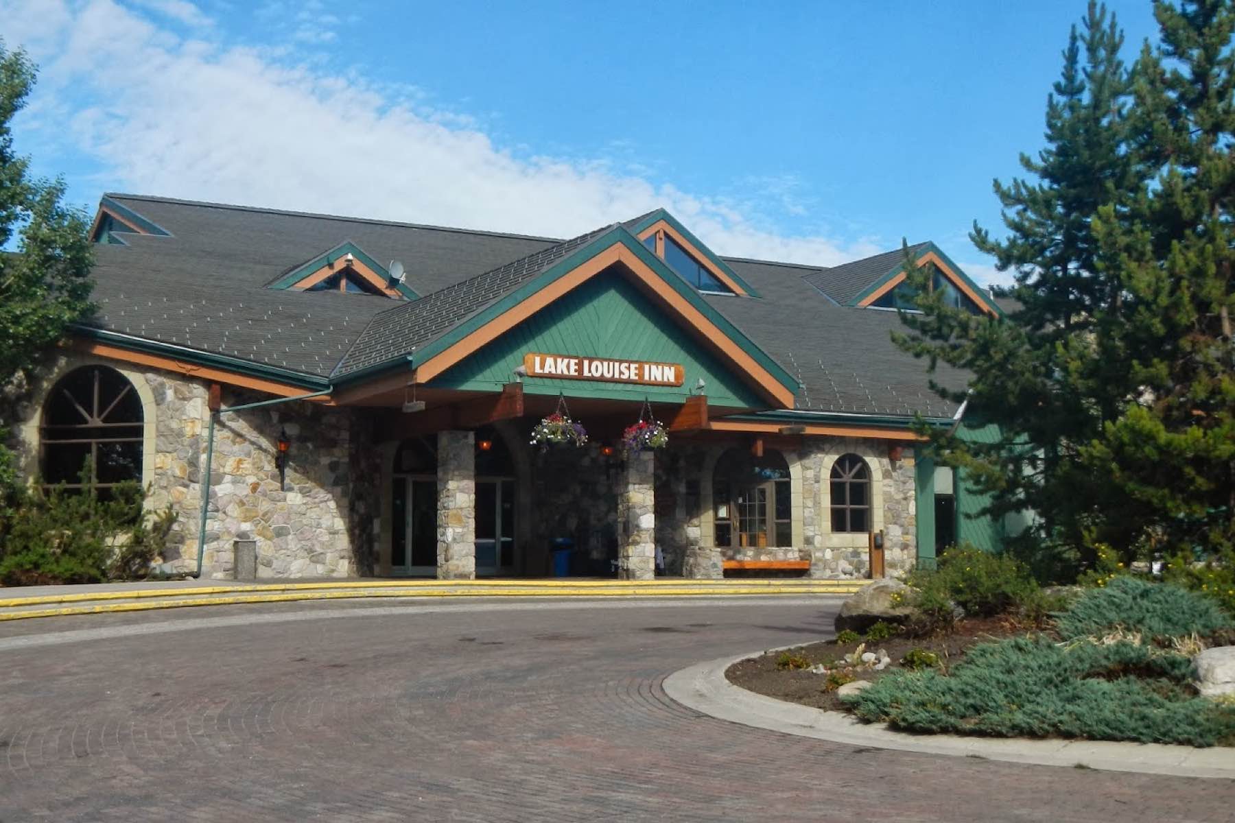 image A charming property entrance surrounded by greenery, welcoming you to a serene retreat.
