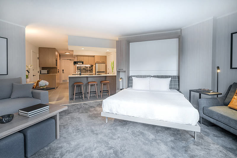 image A beautifully arranged bedroom with a serene color palette and plush bedding, offering a calm and restful retreat.