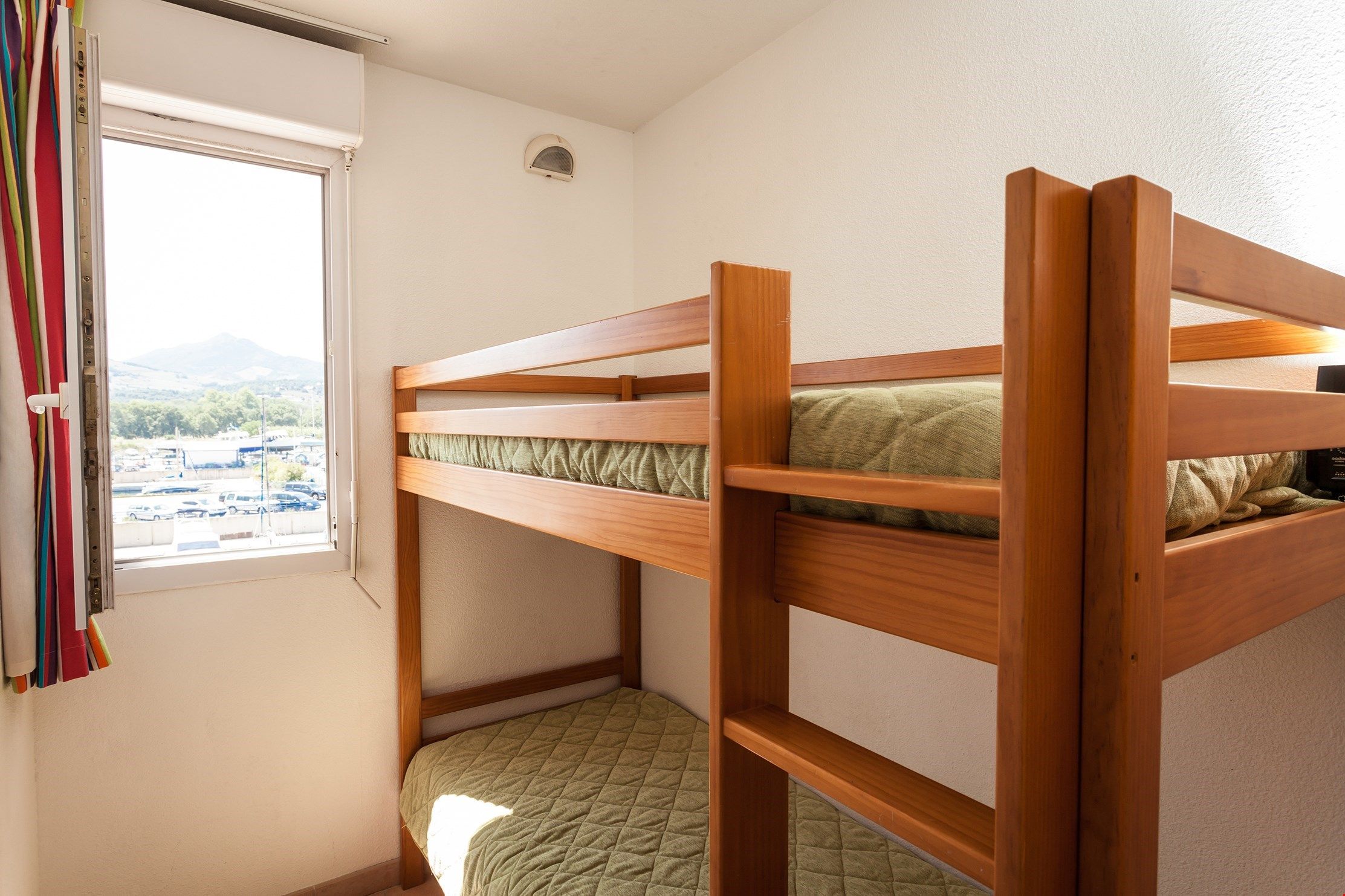 image The cozy sleeping alcove features a bunk bed.