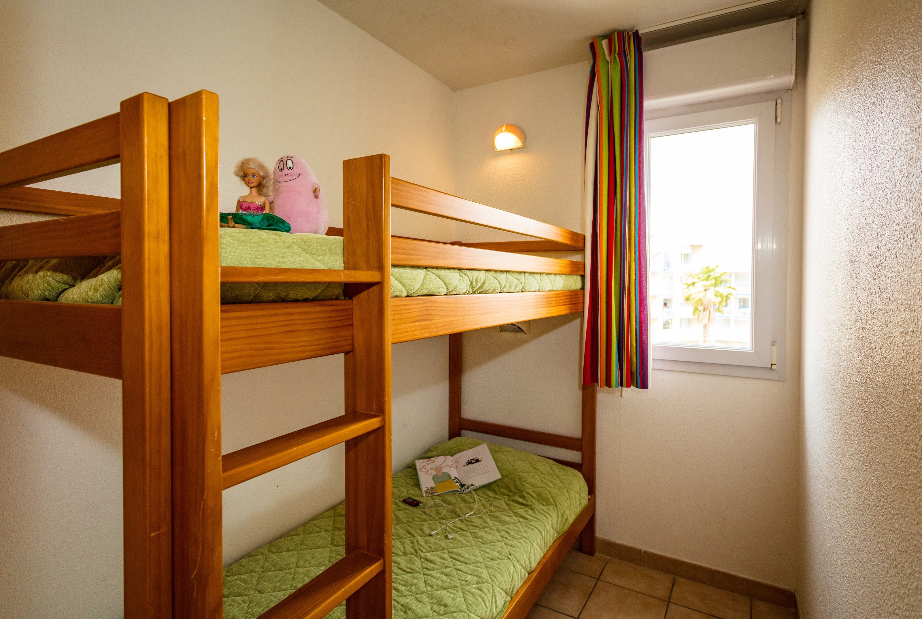 image The cozy sleeping alcove features a bunk bed.