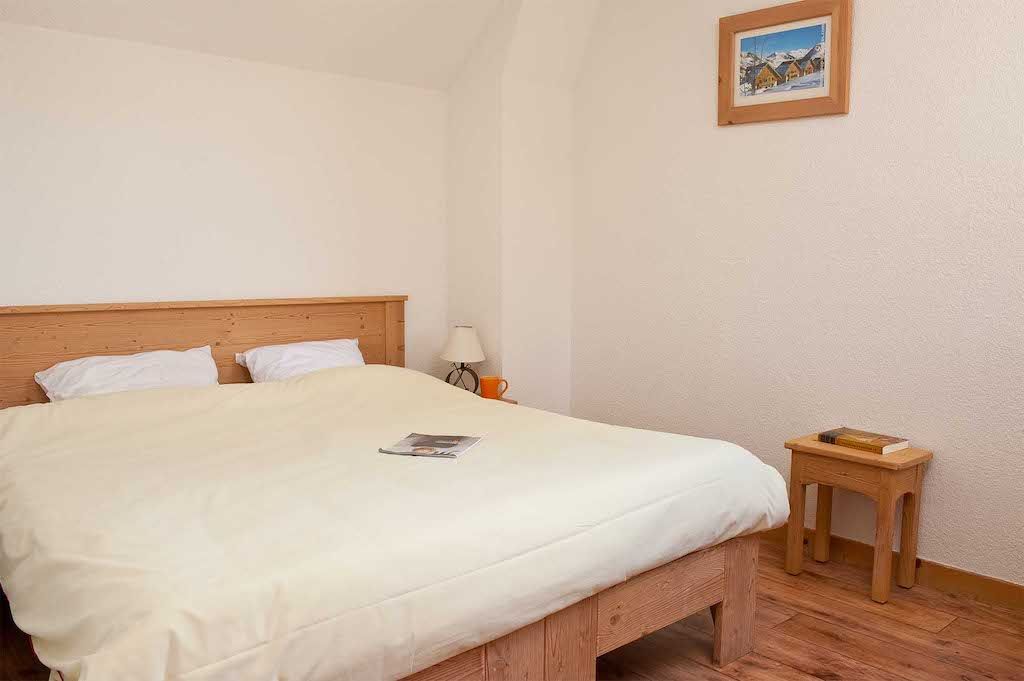 image This charming bedroom, adorned with natural wood furnishings, offers a serene atmosphere perfect for restful nights after outdoor adventures.