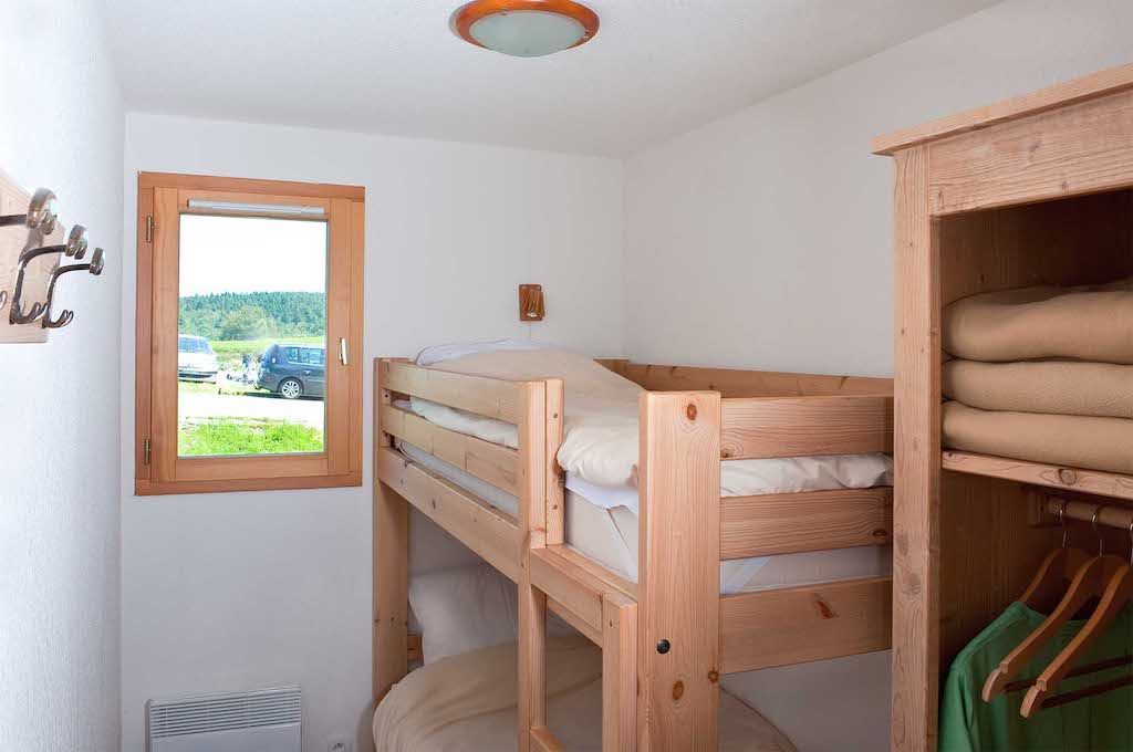 image The snug bunk room is ideal for kids or guests, complete with lovely views of the surrounding mountains through its bright window.