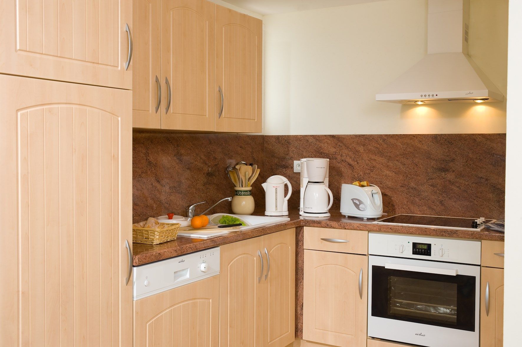 image Prepare meals in the full kitchenette and enjoy them at the dining table.
