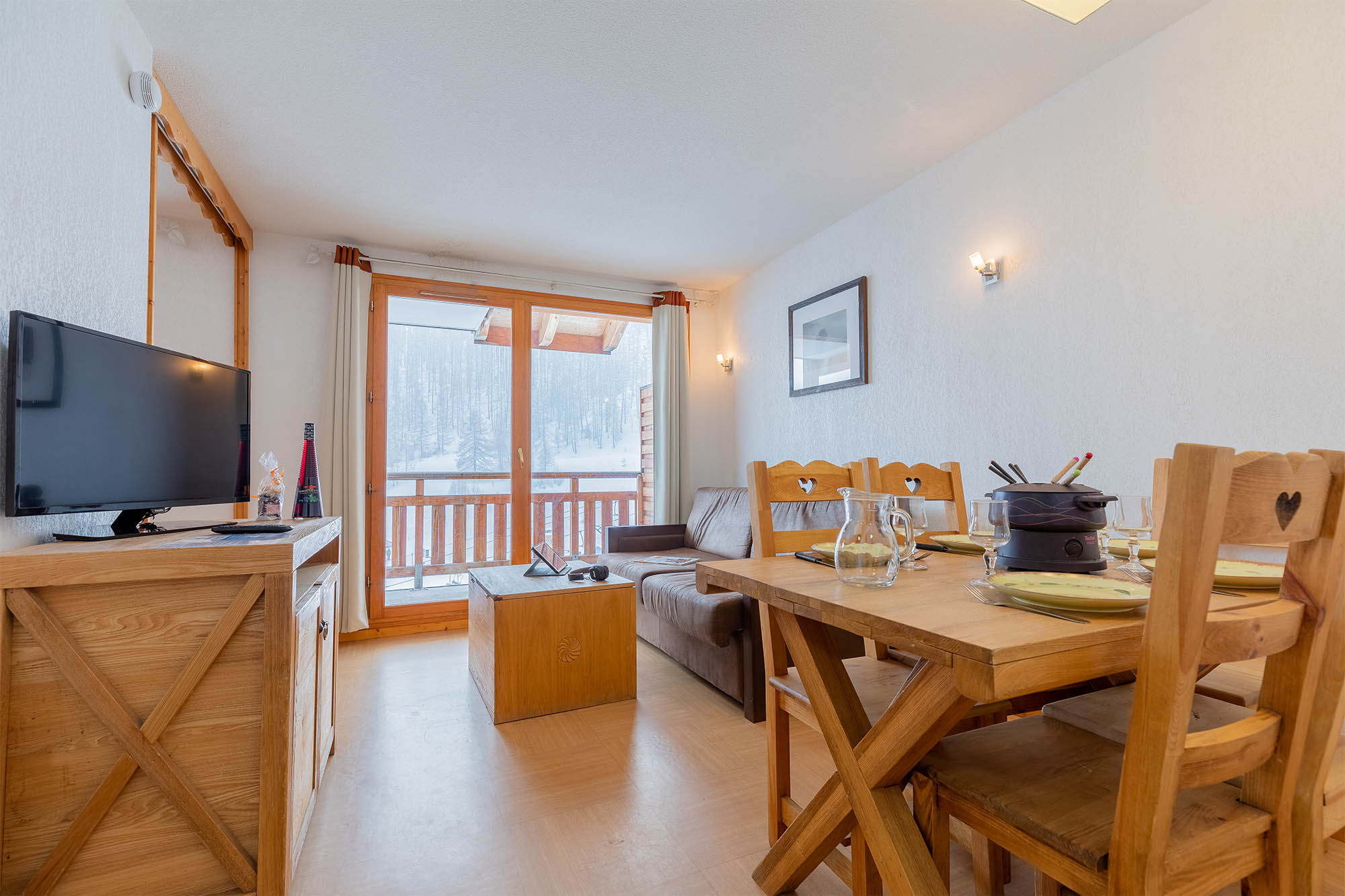 image Living area with sofa bed, dining table and balcony view