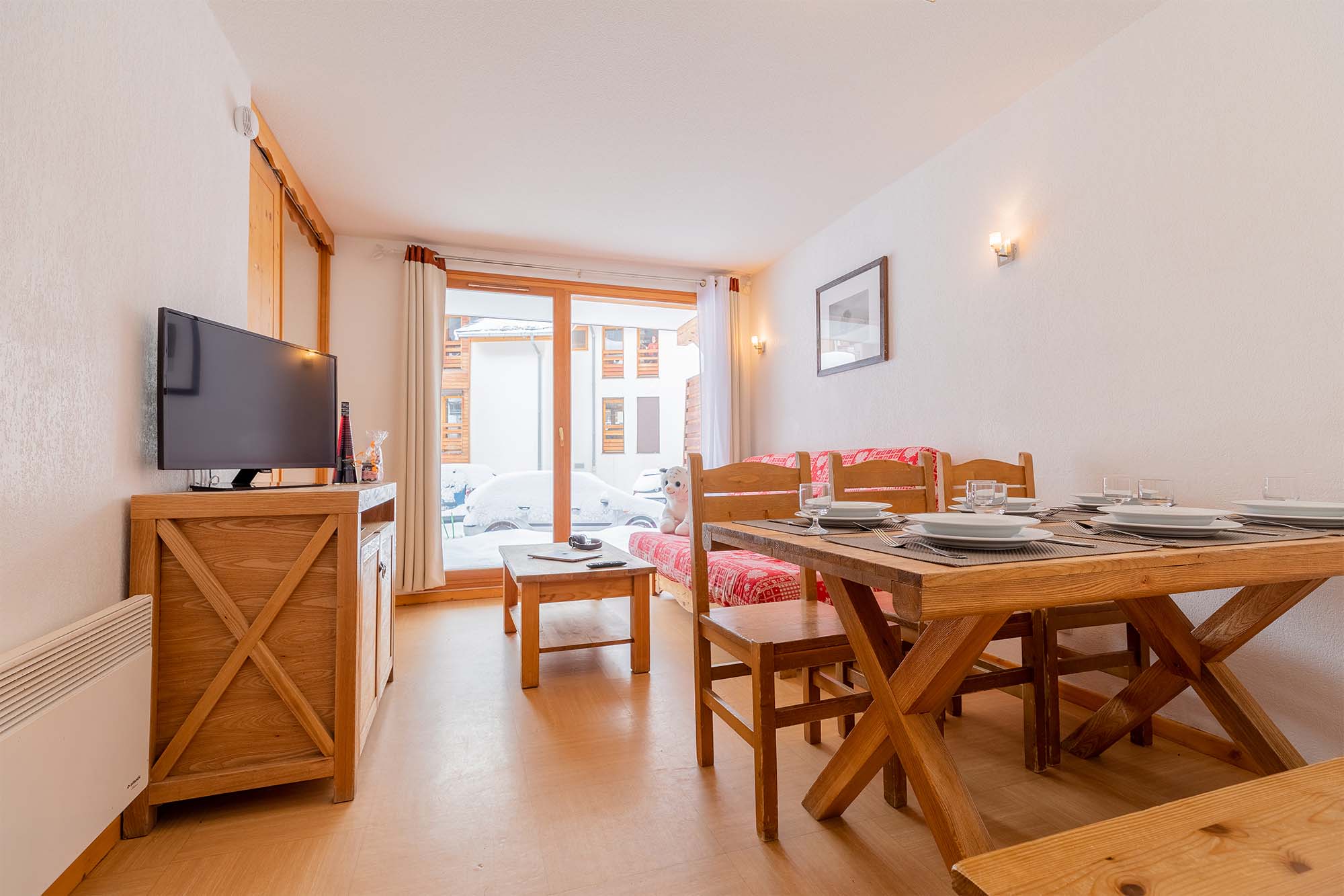image Living area with dining table, chairs and TV stand