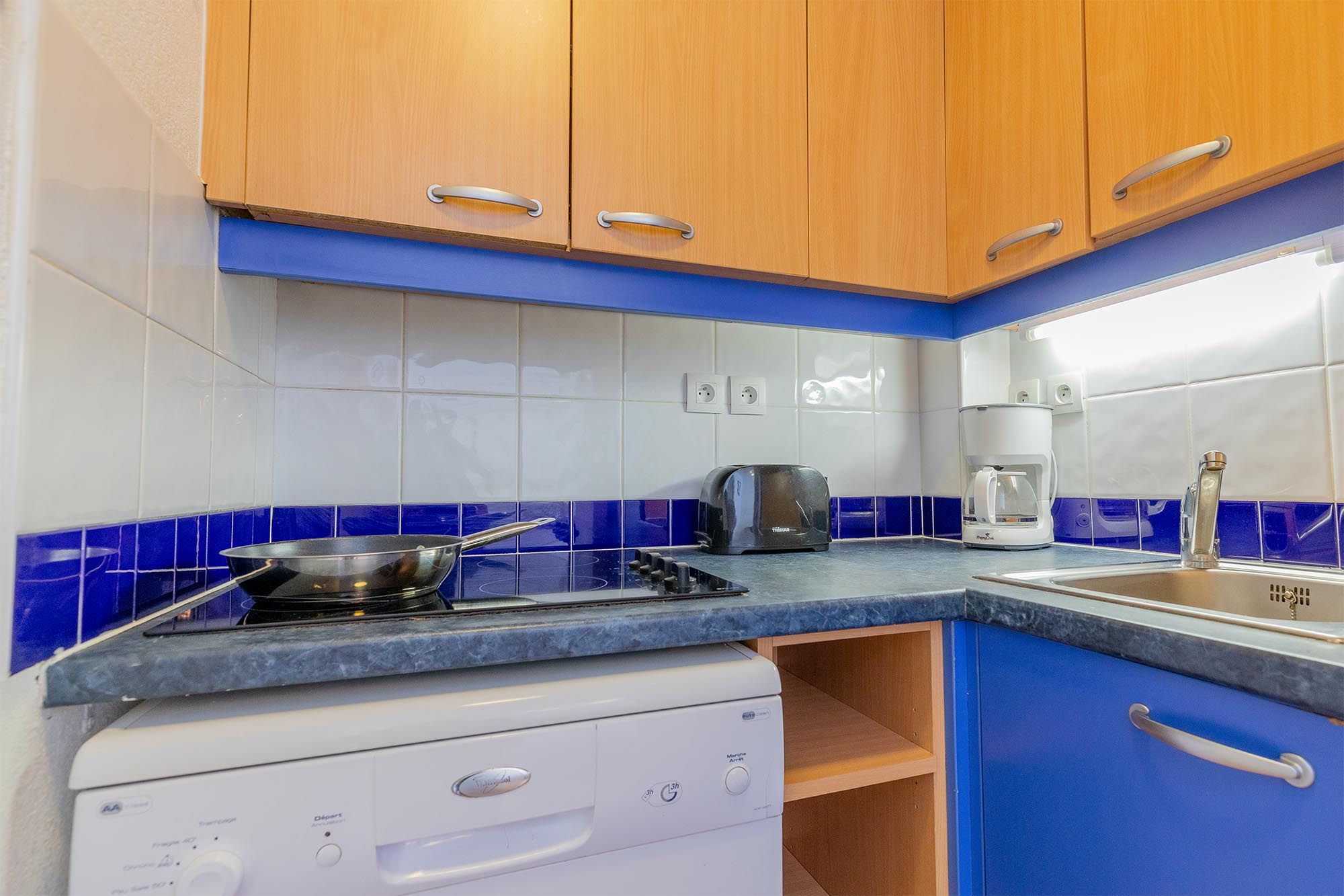 image Kitchen with dishwasher, stove and countertop appliances