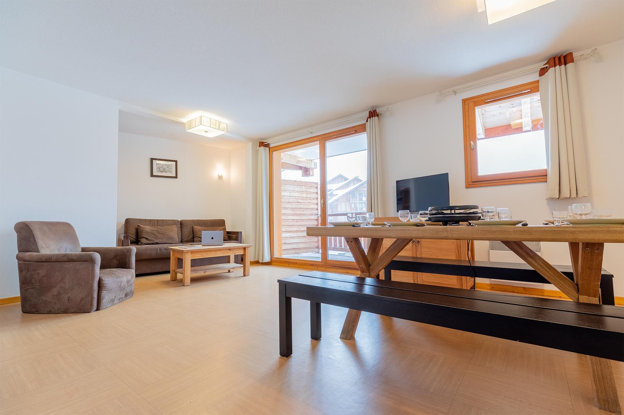 image Living area with sofa bed, balcony access and dining table