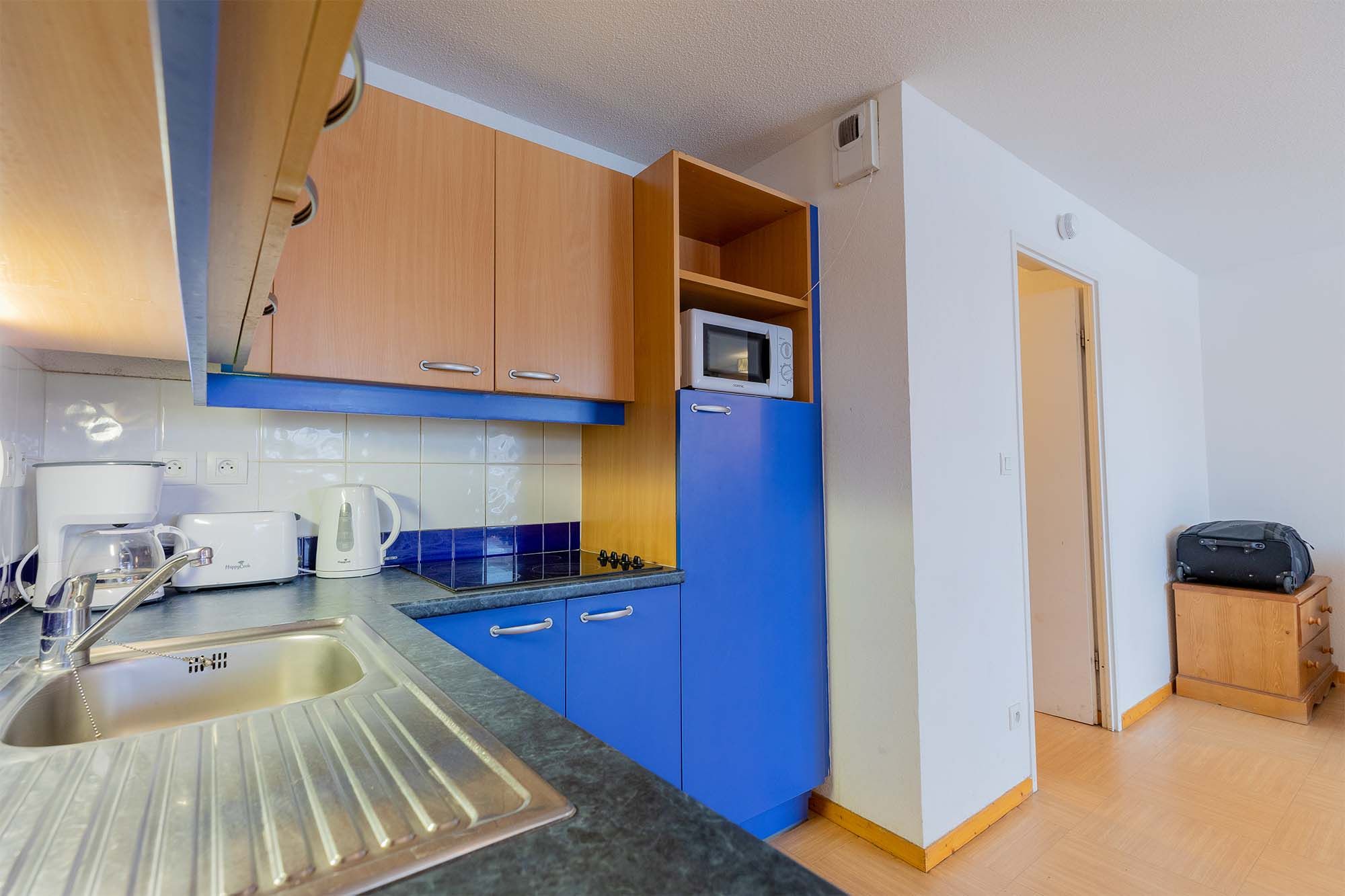 image Kitchen with appliances, sink and storage cabinet