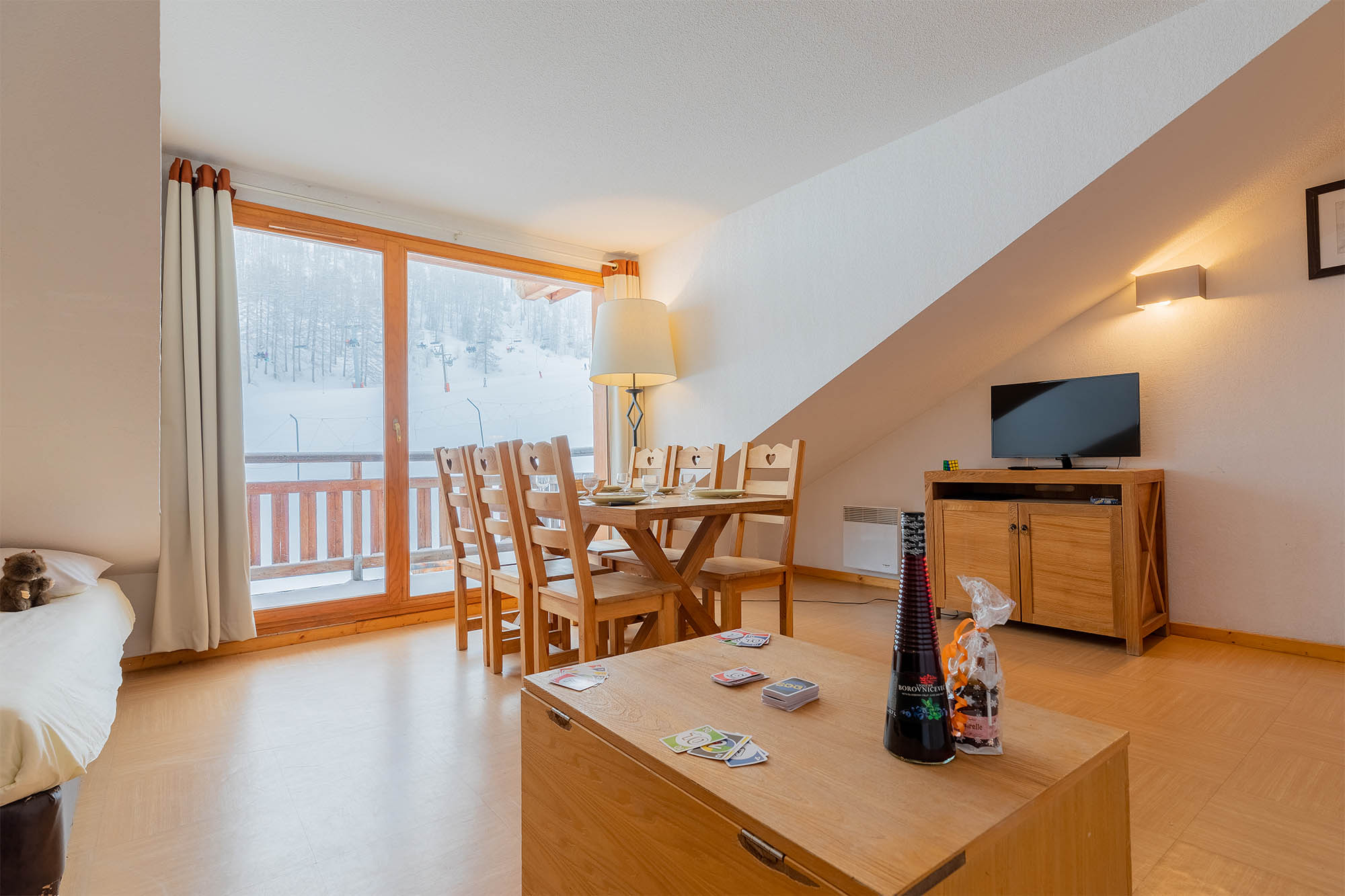 image Living area with dining table, TV and window view
