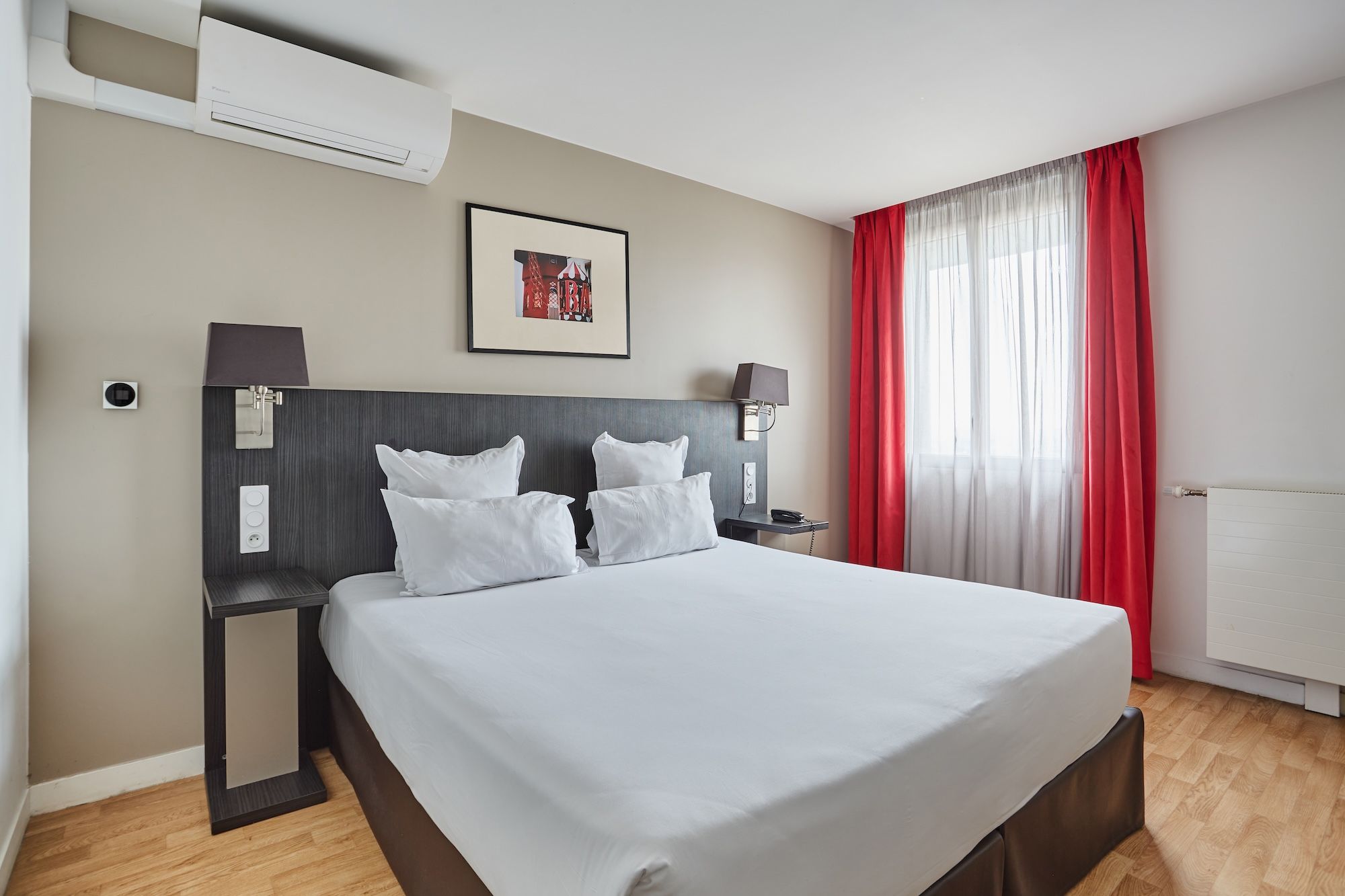 image Studio sleeping area with red accent curtains and a cozy double bed, ideal for a restful city break.