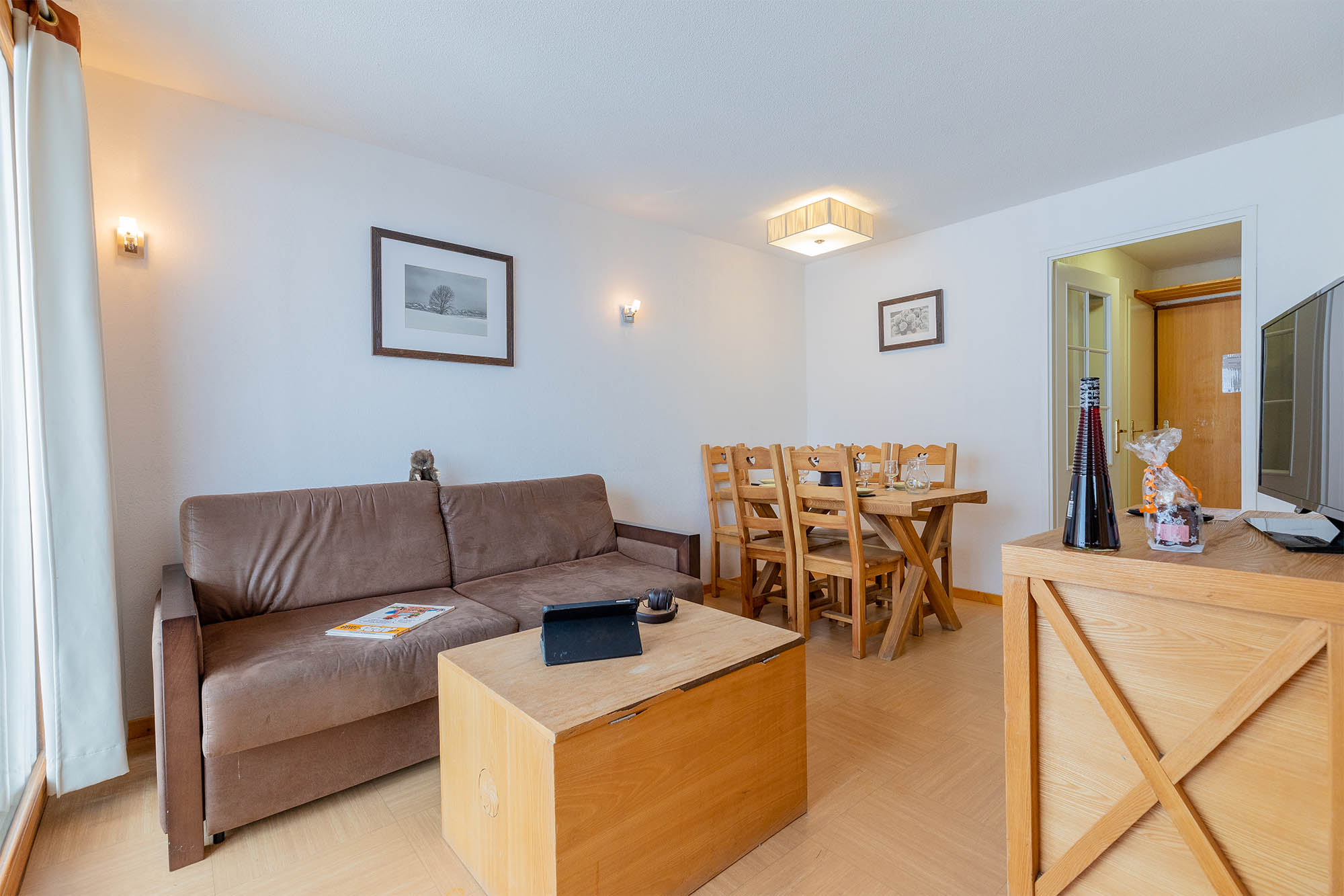 image Living area with sofa bed, dining table and entrance
