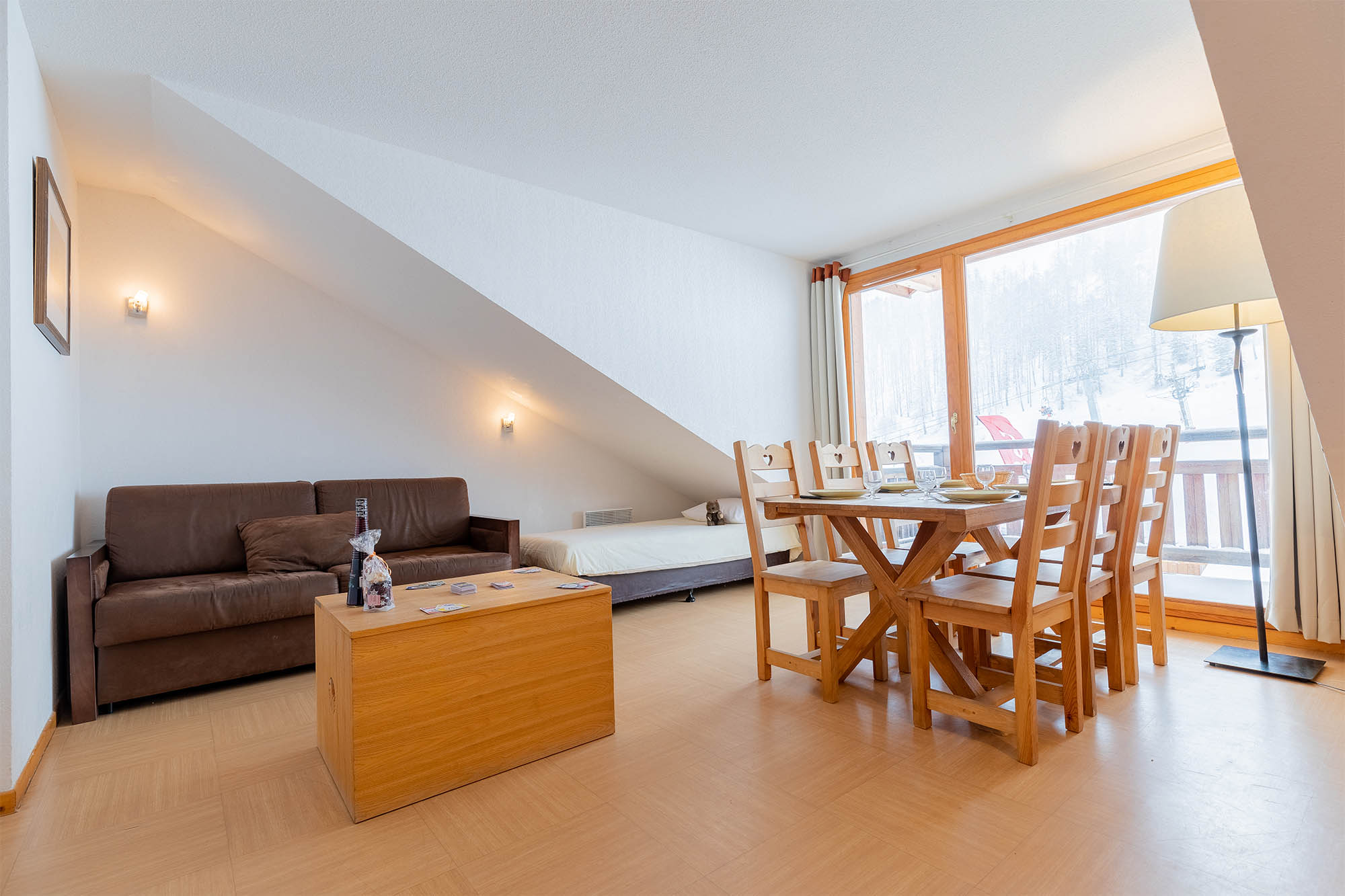 image Living area with sofa bed, dining table and large window