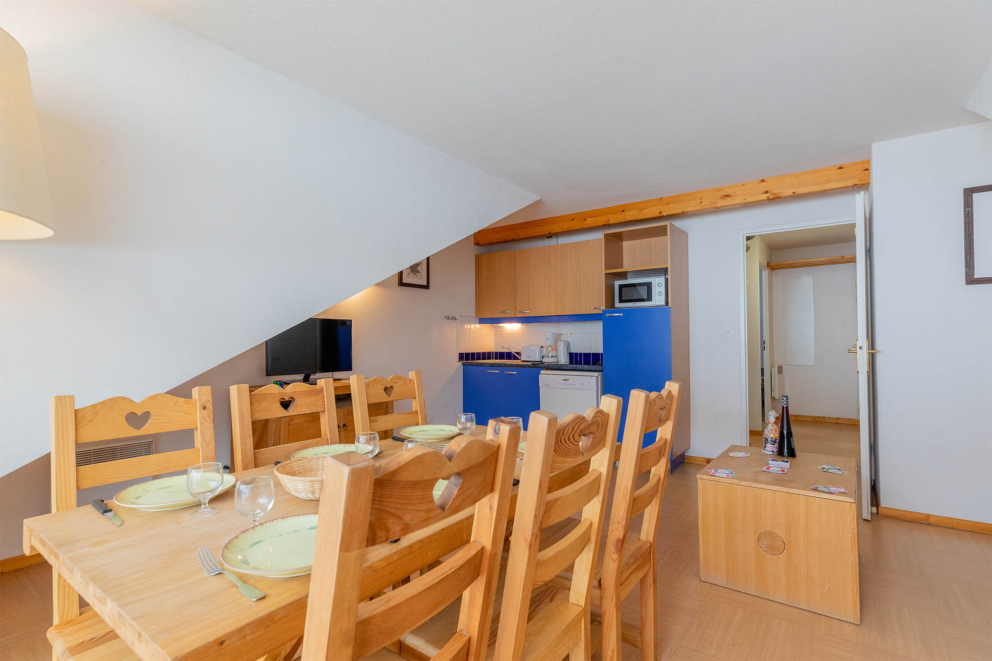 image Dining area leading to a compact kitchen