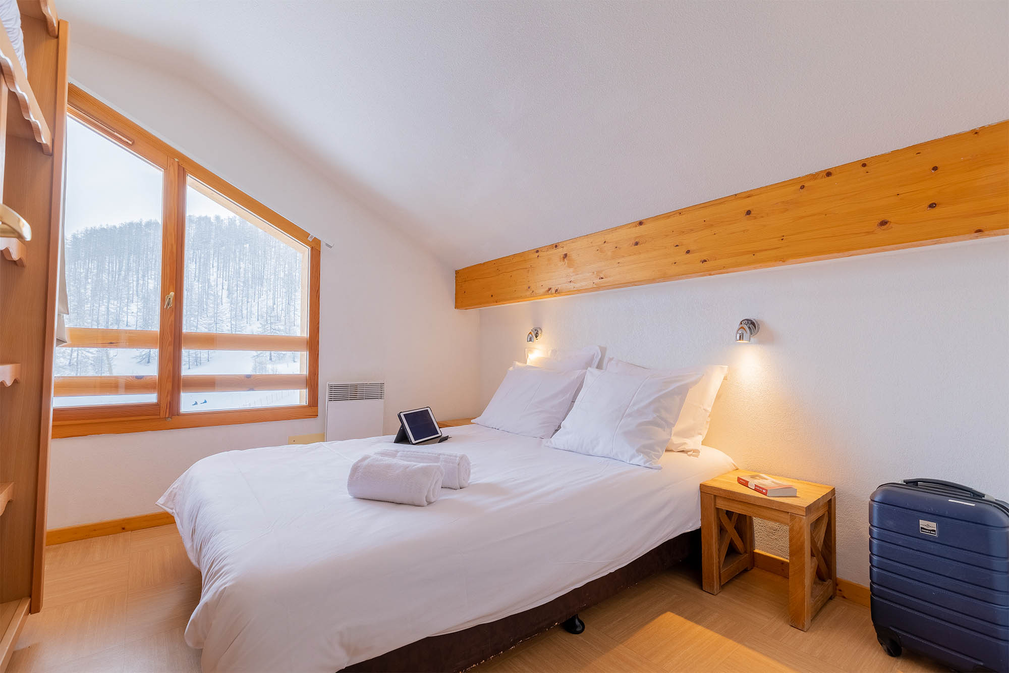 image Bedroom with double bed, sloped ceiling and large window