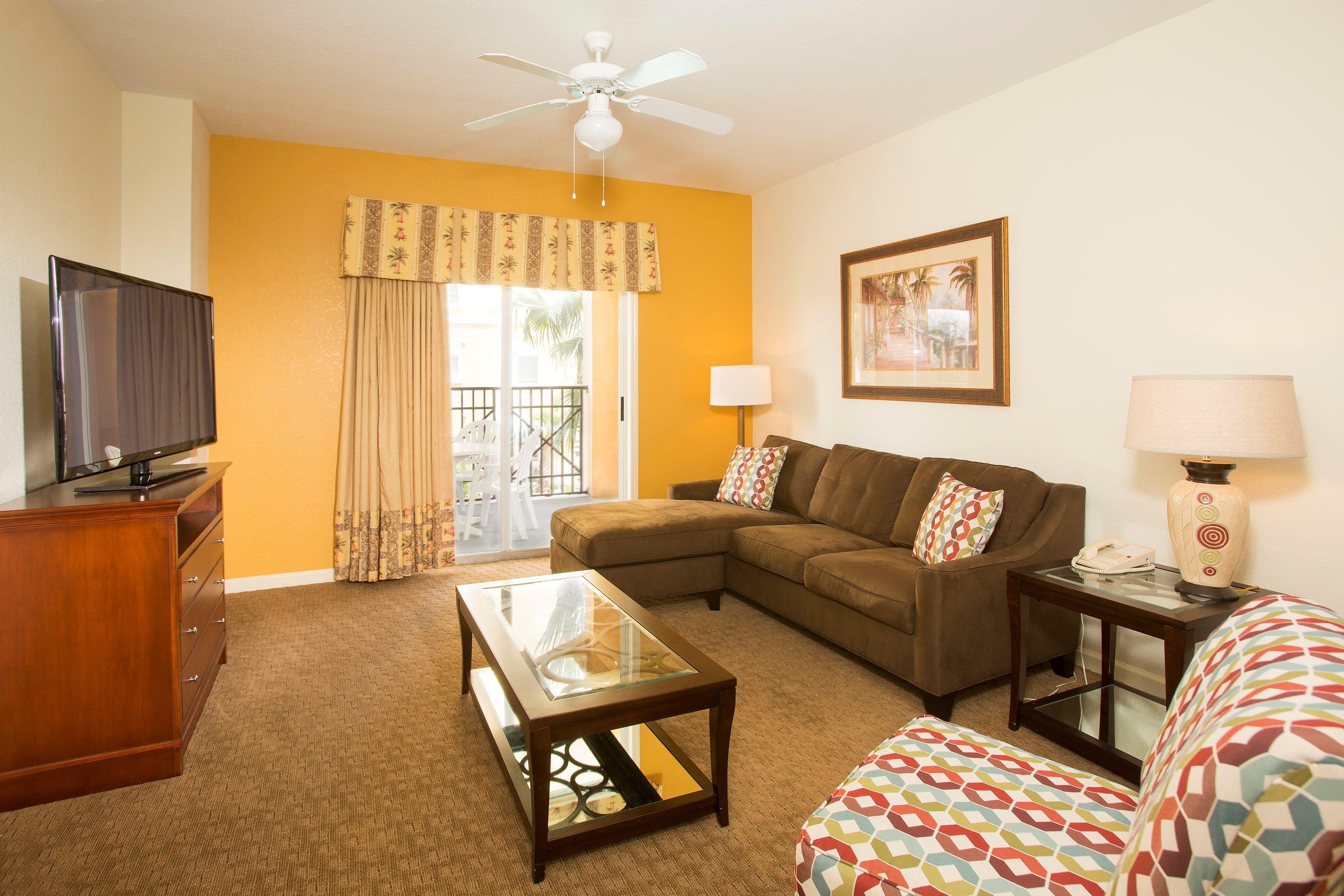 image Find peace and relaxation with your close friends and family in this lovely living room featuring colorful decor.