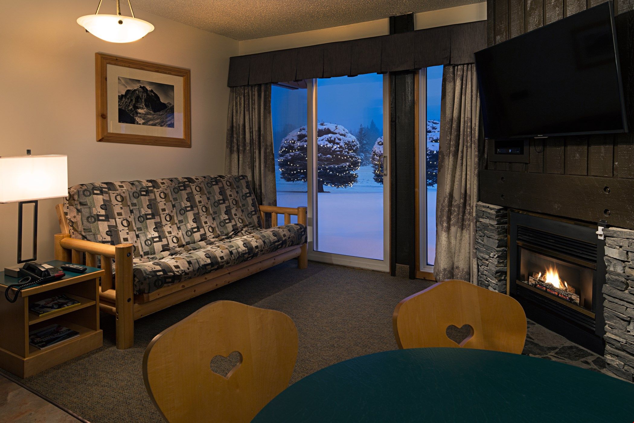 image The gorgeous living area features a sofa, a flat-screen TV and a gas fireplace.