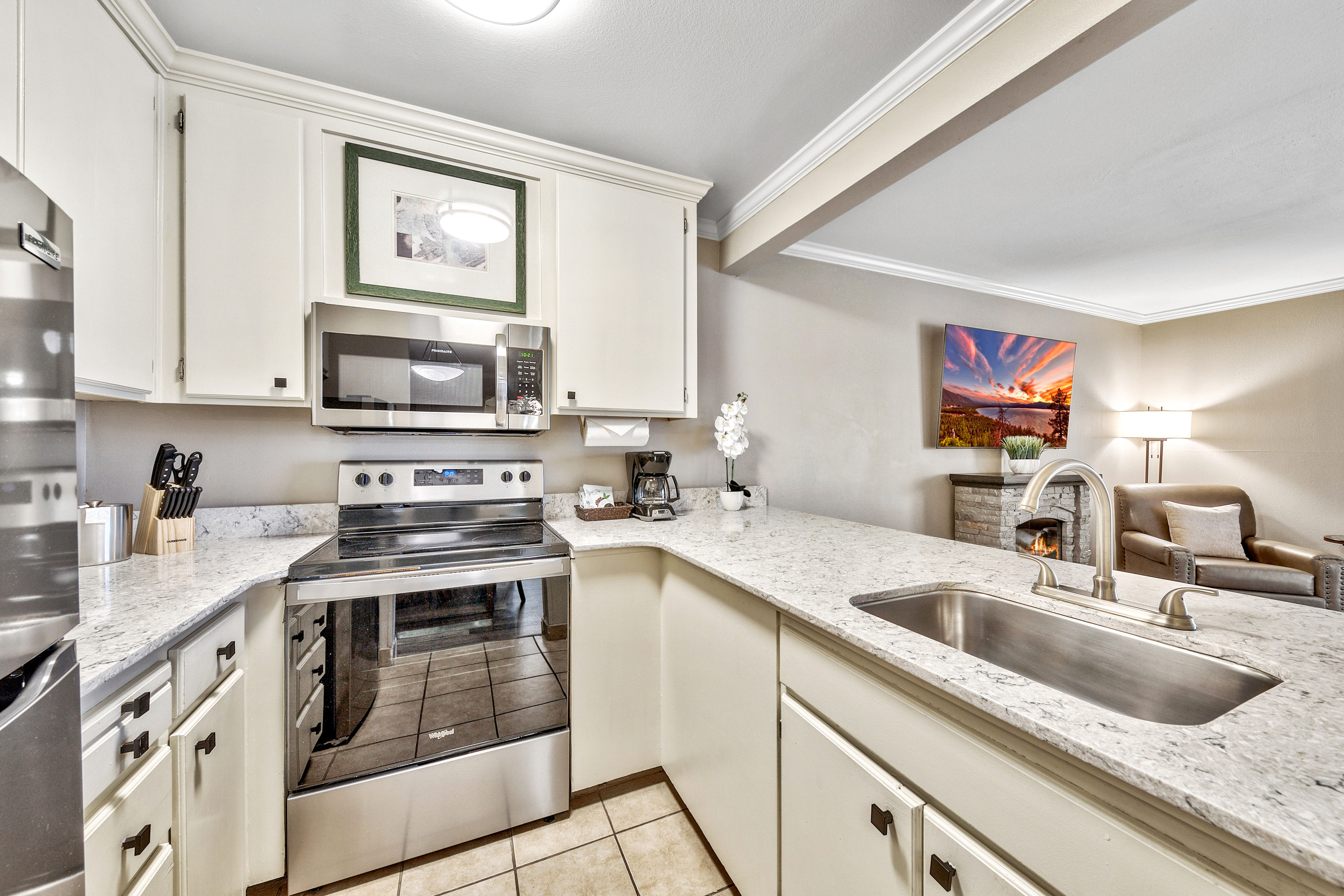 image A well-equipped kitchen with modern appliances, sleek countertops, and an open layout, perfect for preparing meals with ease.