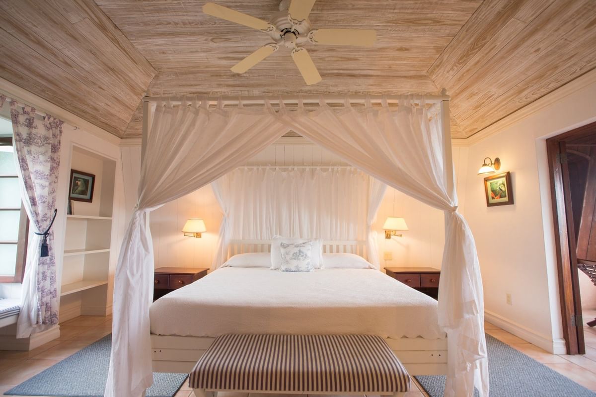 image Cozy bedroom with a four-poster canopy bed and warm ambient lighting.