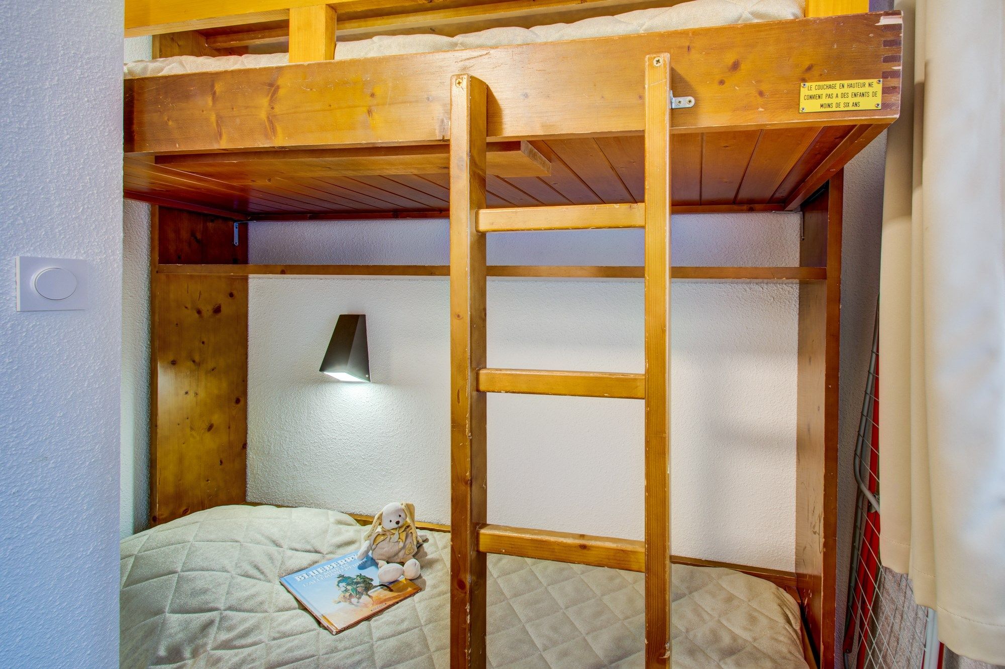 image The cozy sleeping alcove features a bunk bed.