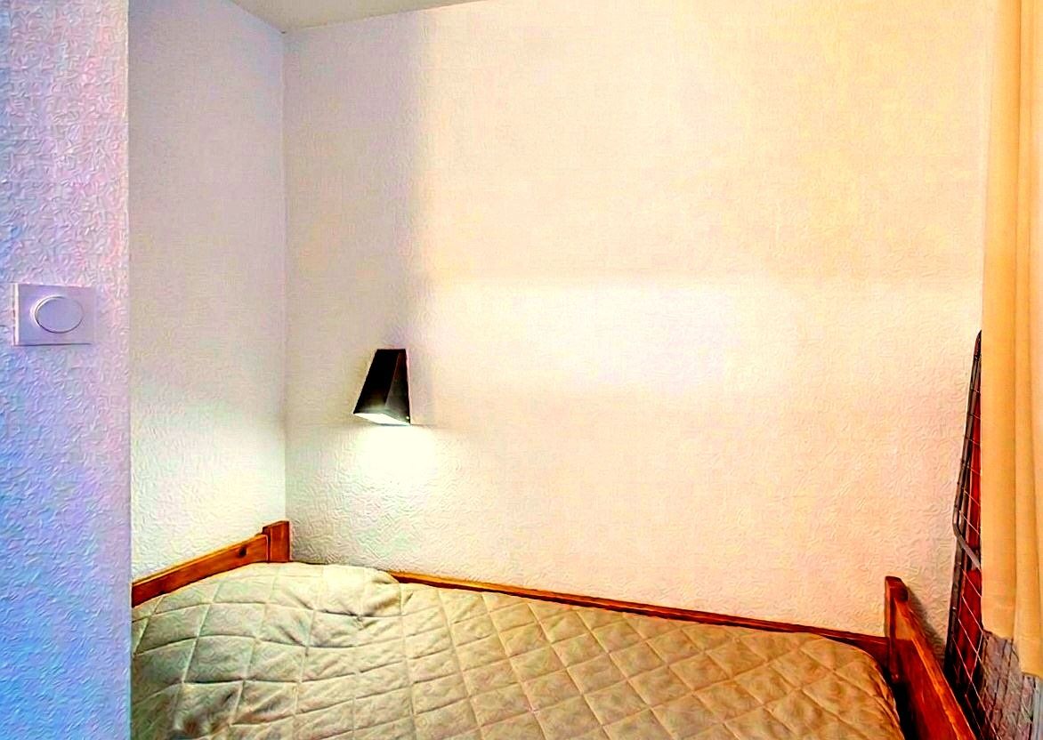 image The cozy sleeping alcove features a single bed.