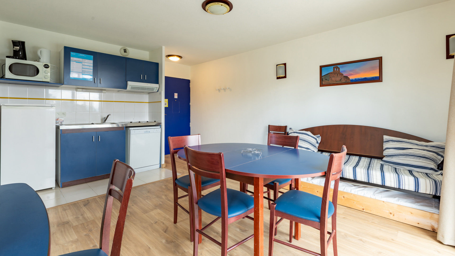 image Bright and welcoming space with a fully equipped kitchenette, dining table, and a cozy seating area—perfect for unwinding after a day of exploring.