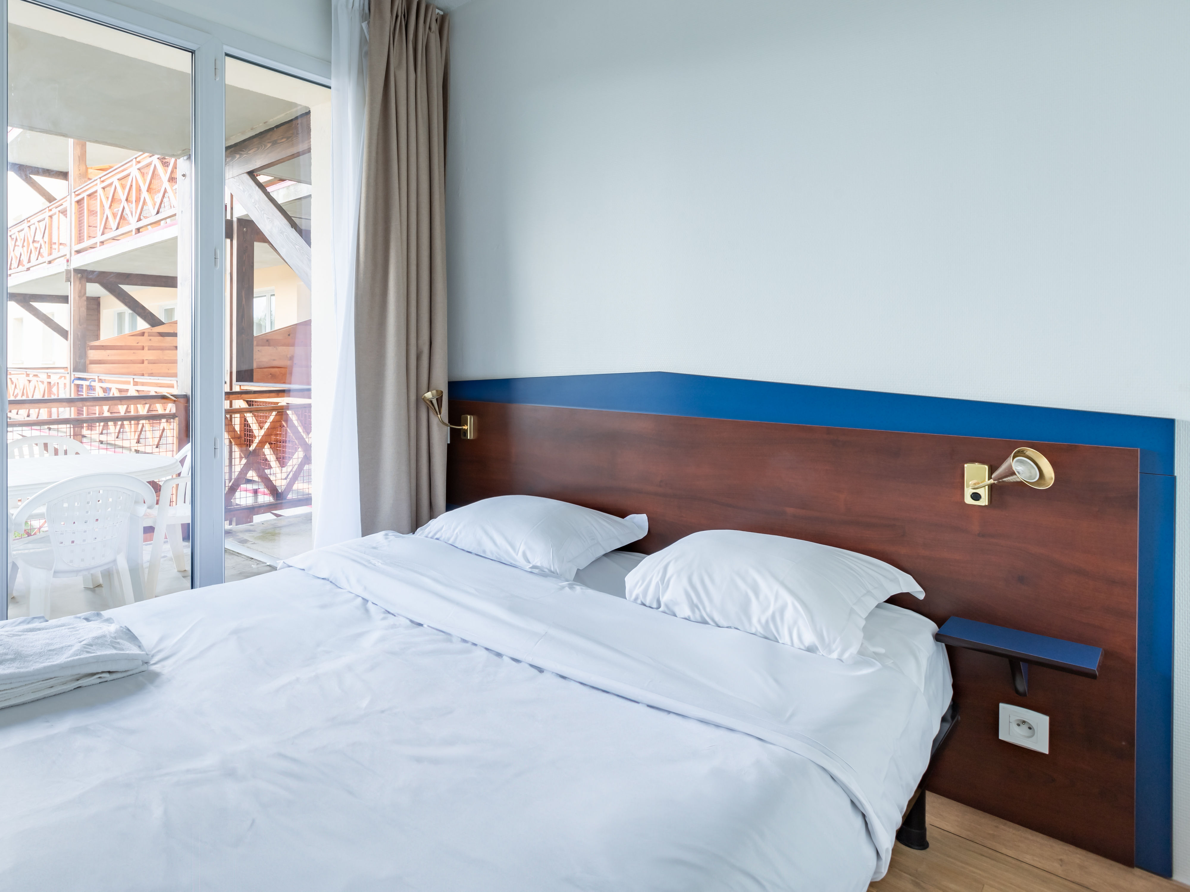 image Sliding doors lead from this double bedroom onto the balcony for fresh mountain air before breakfast.
