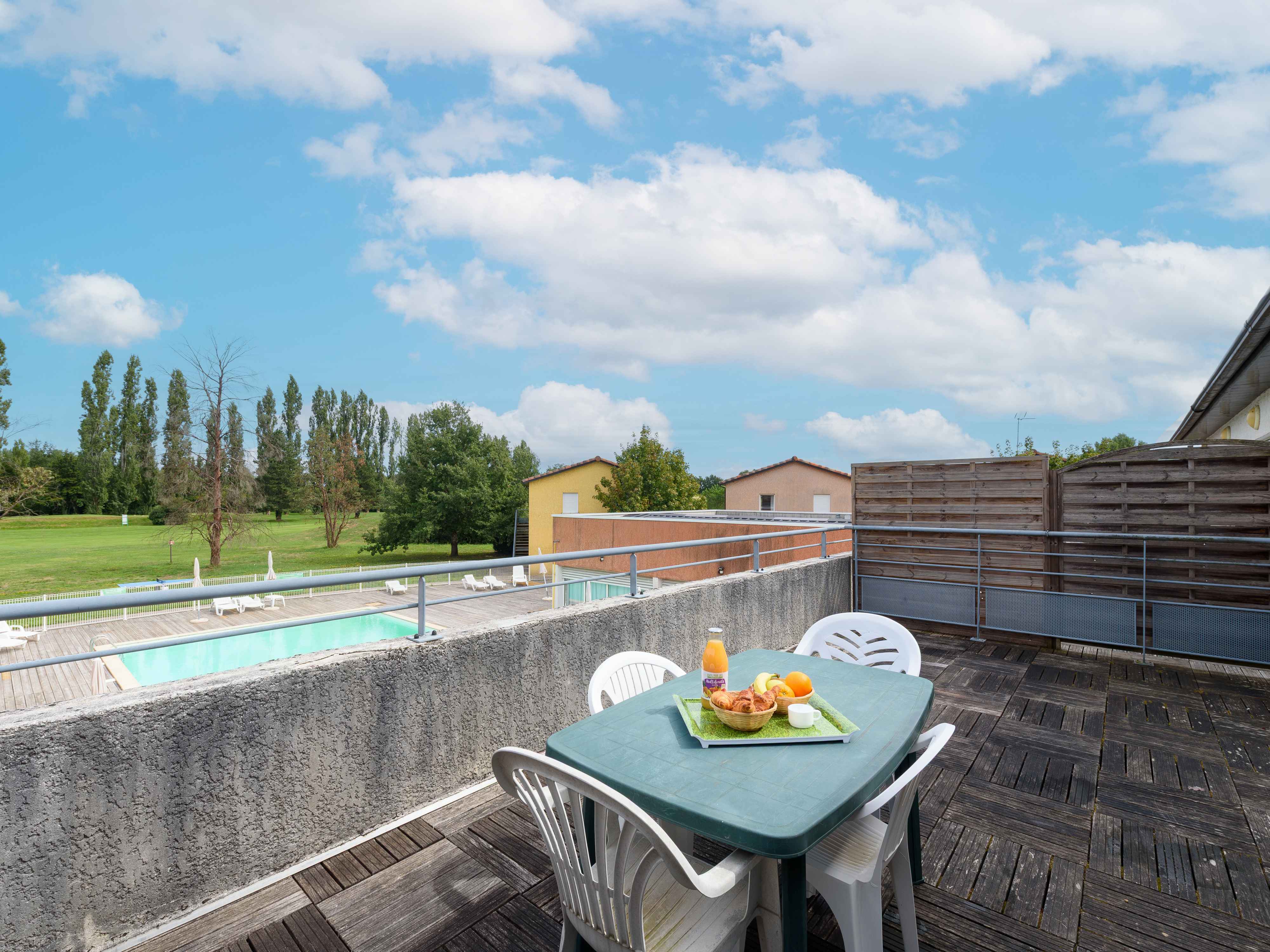 image Enjoy breakfast on the spacious terrace, complete with a stunning view of the pool and surrounding greenery, perfect for relaxation.