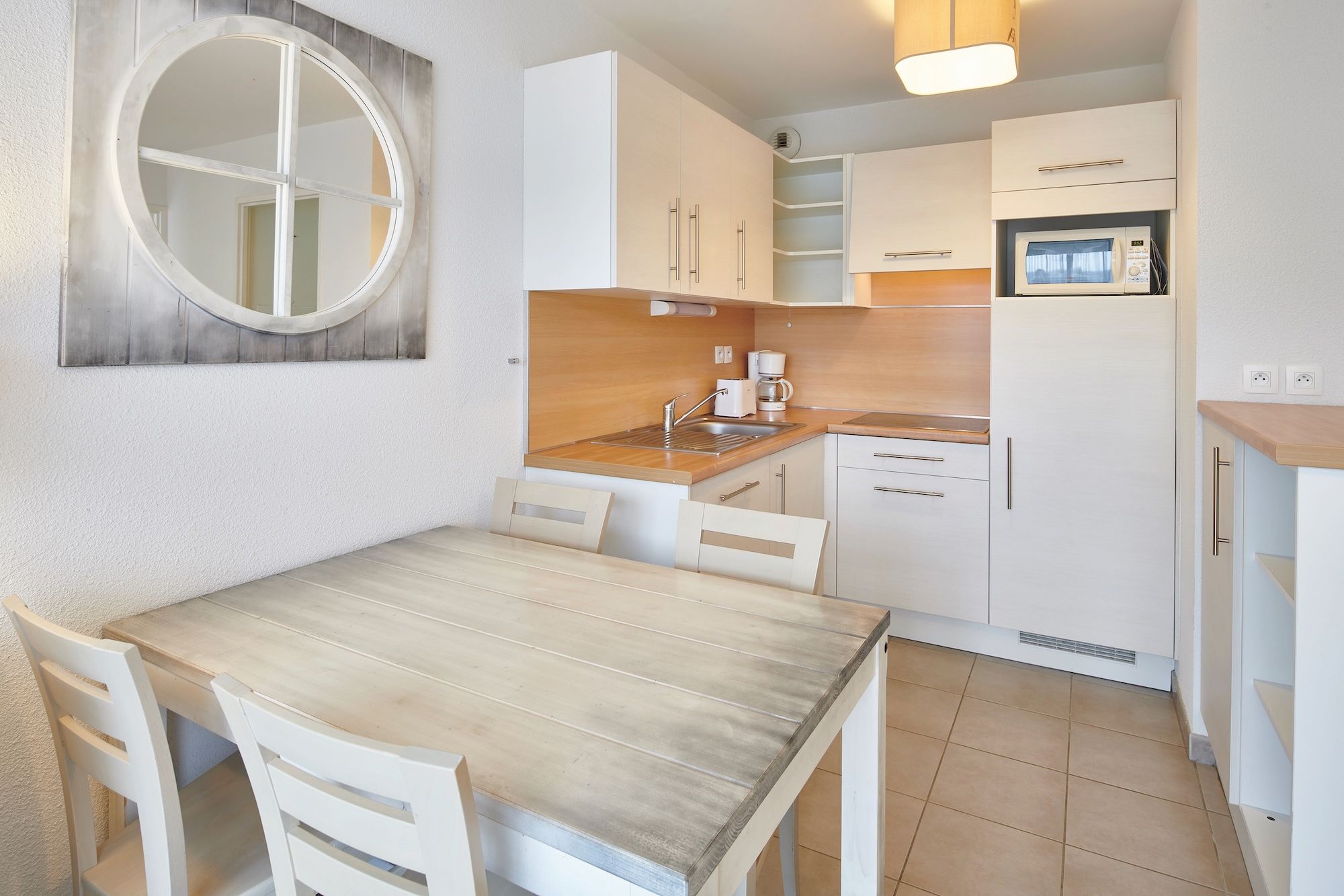 image Prepare meals on the ceramic hobs, with the microwave, fridge and dining table all in the same kitchenette