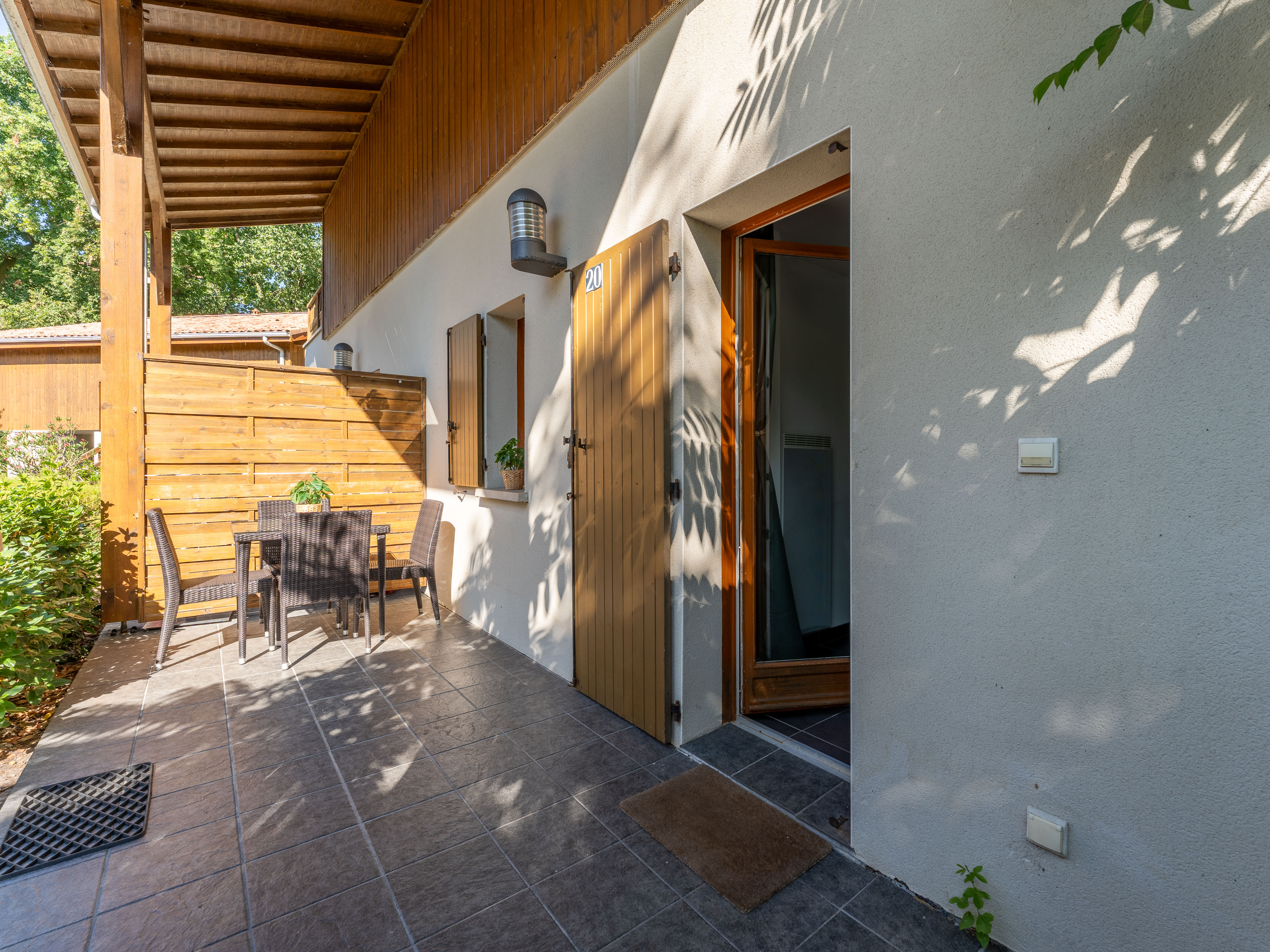 image A private terrace shaded by lush greenery — your own outdoor retreat after a day cycling the lakeside paths or exploring the Médoc.