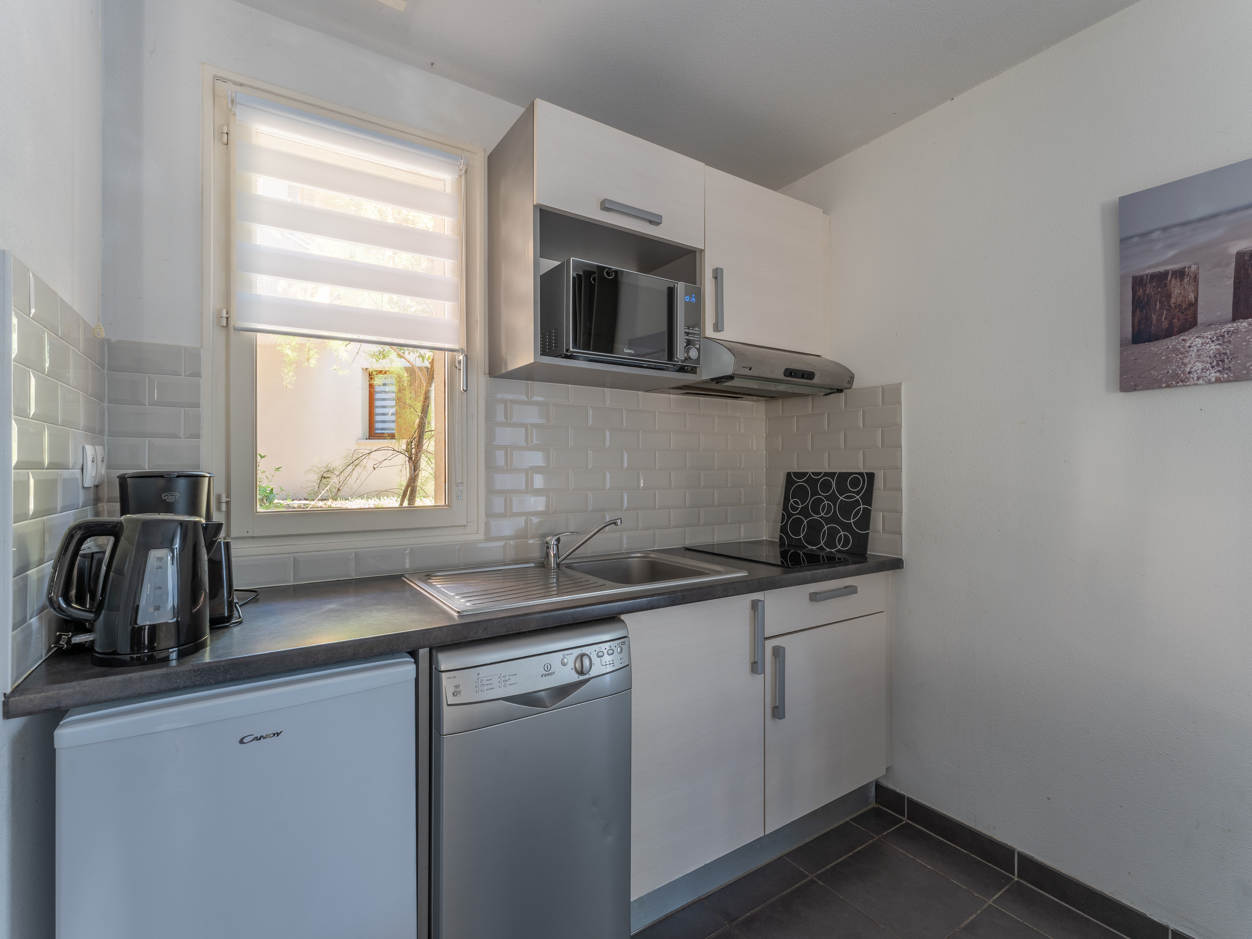 image The fully equipped kitchenette — ceramic hob, microwave, dishwasher, coffee maker and more — everything you need to settle in and stay a while.