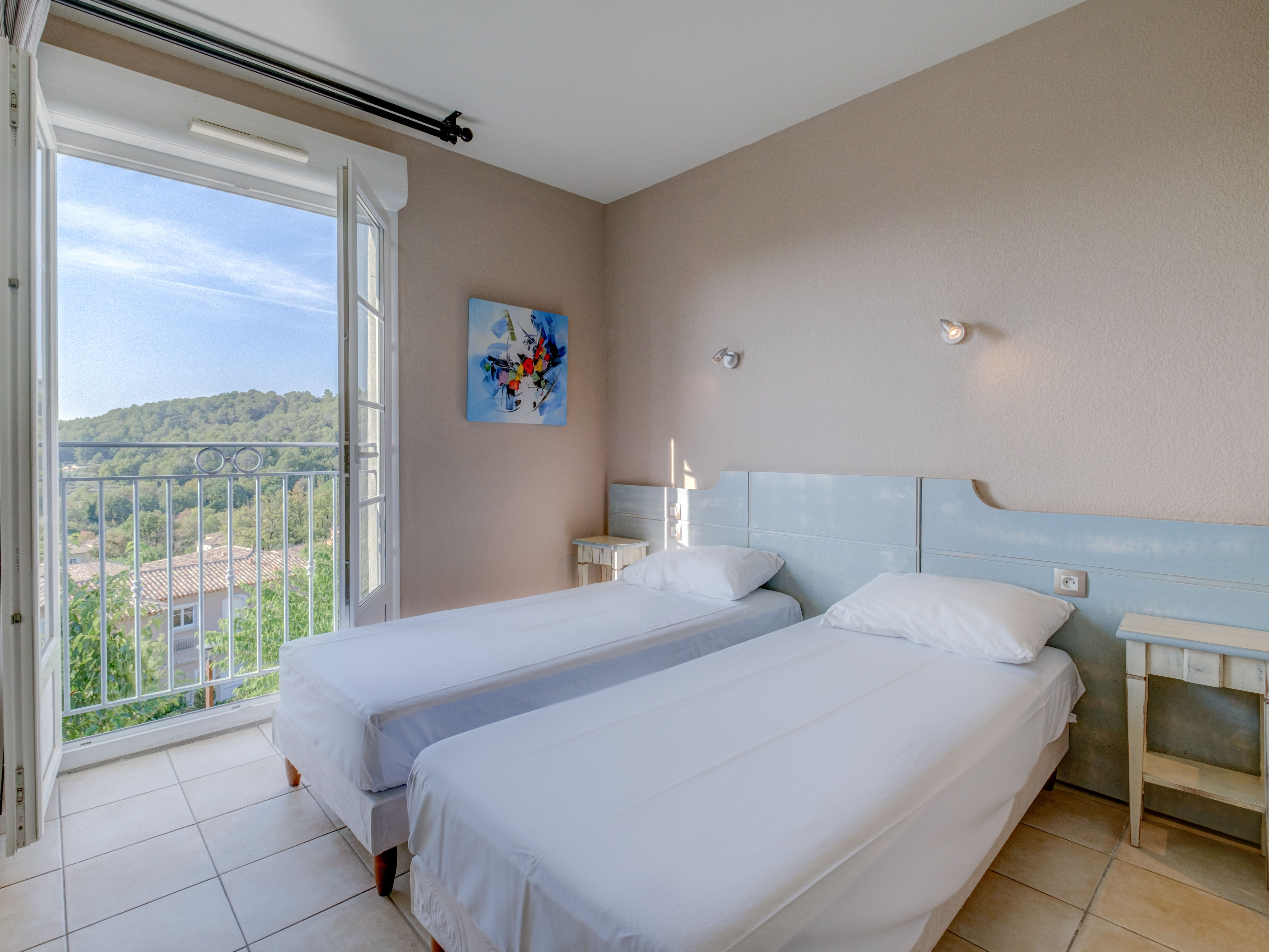 image Cozy and inviting beds filled with gentle light and sweeping hillside views, ideal for waking up slow.