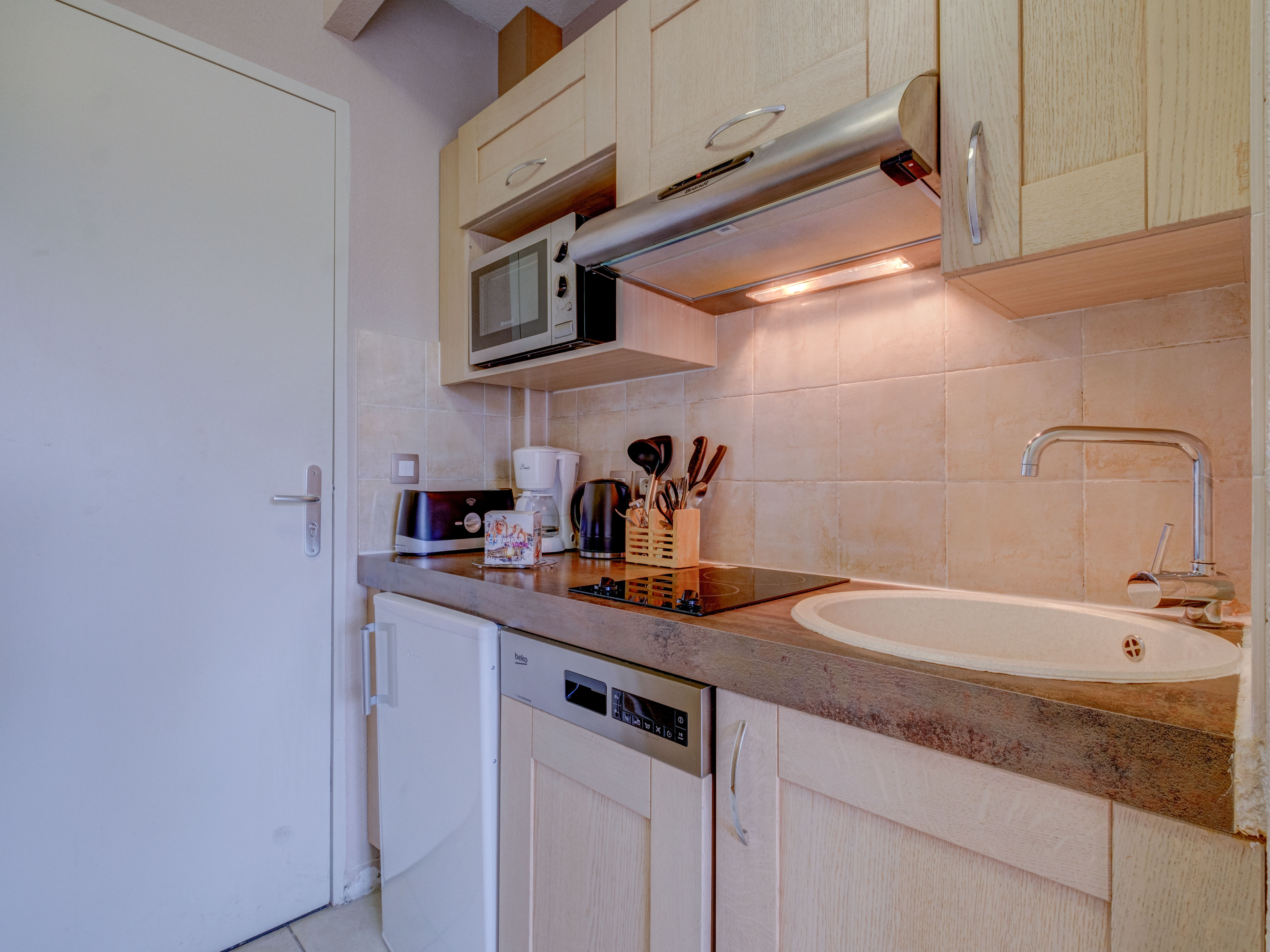 image Warm wood tones and soft lighting create an inviting kitchen nook, perfect for slow breakfasts before exploring the hills.