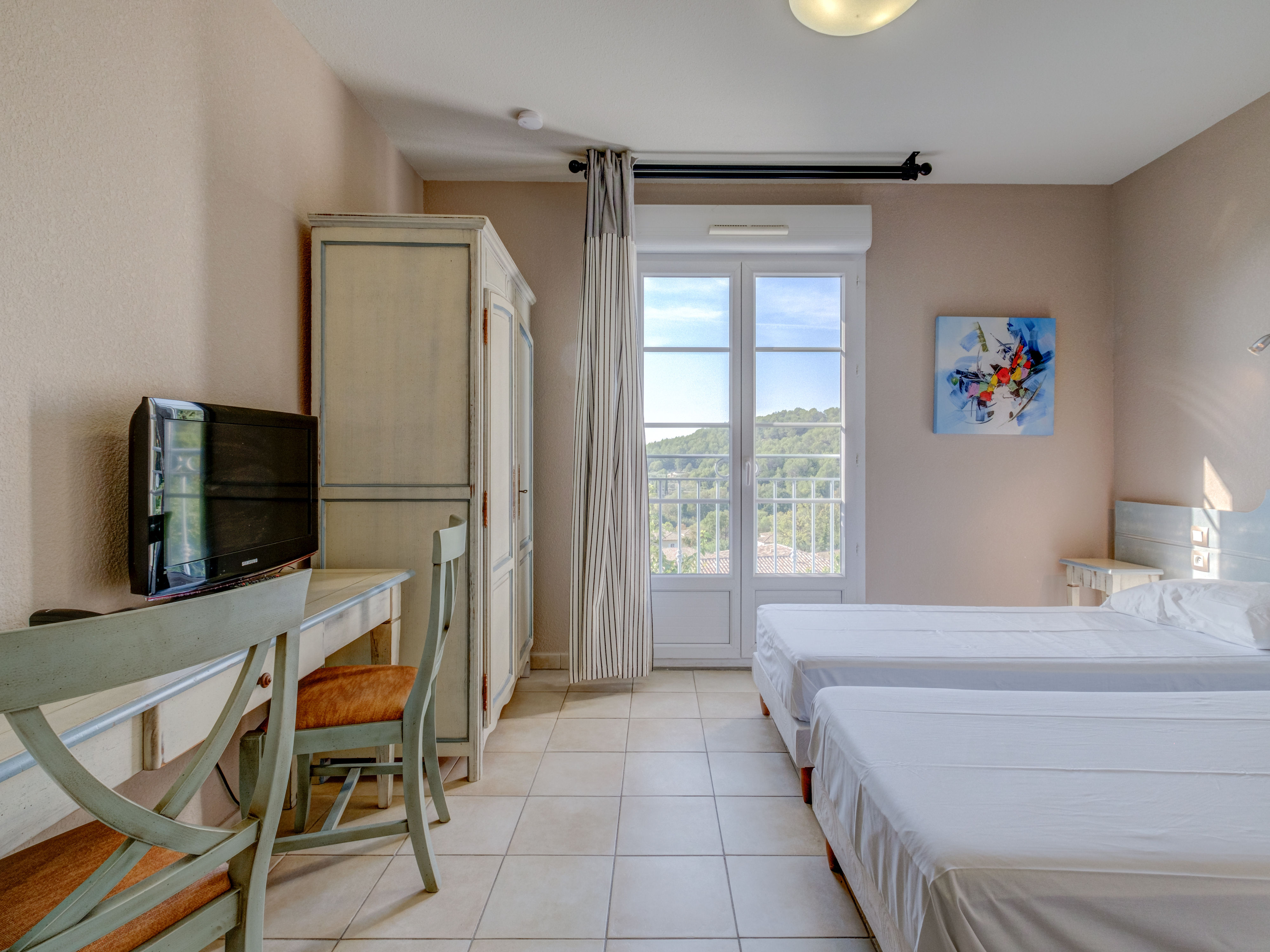 image Sunlight pours into this serene studio, where soft hues and scenic hilltop views set the tone for restful mornings and peaceful evenings.