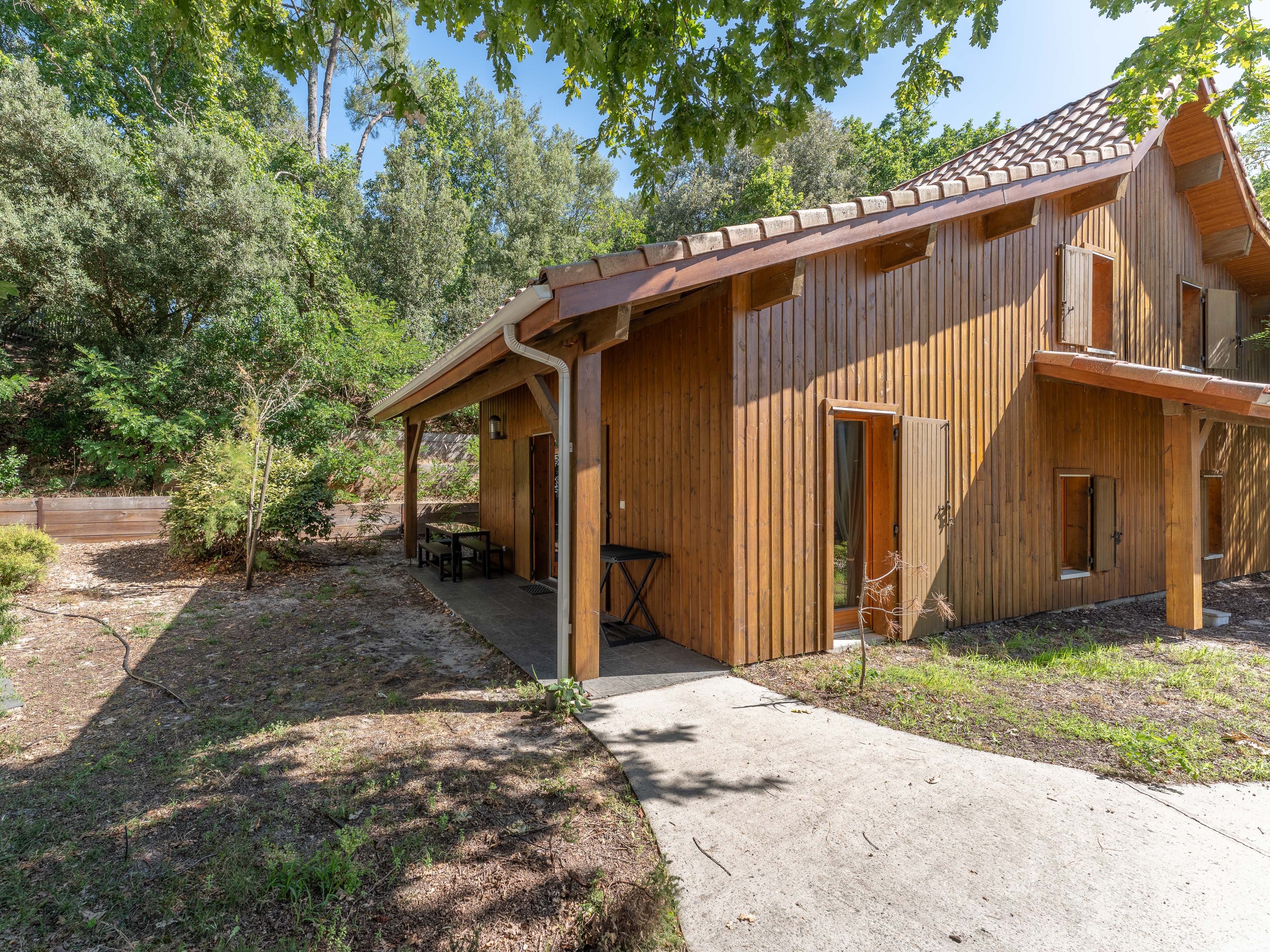 image The timber-clad apartment building set among the Lacanau pines — a welcoming, nature-immersed base for groups of up to eight exploring the lake, the forest and the Atlantic coast.