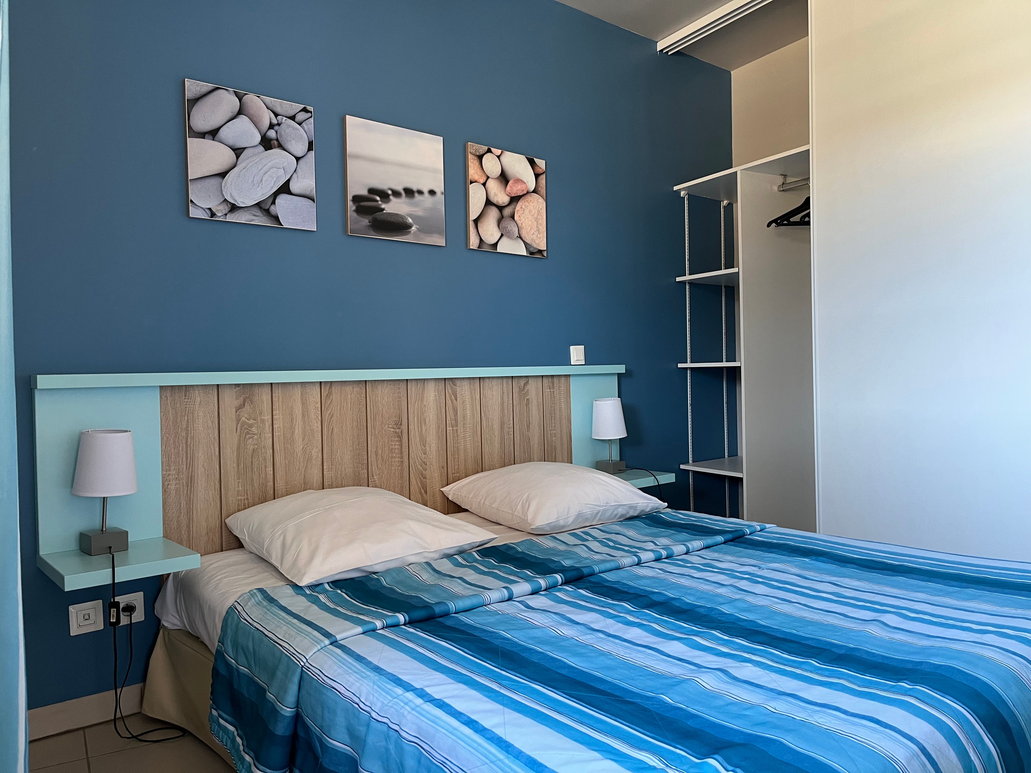 image Blue-striped double bed with twin reading lamps — kick back after a day at the beach, 50m from your door.