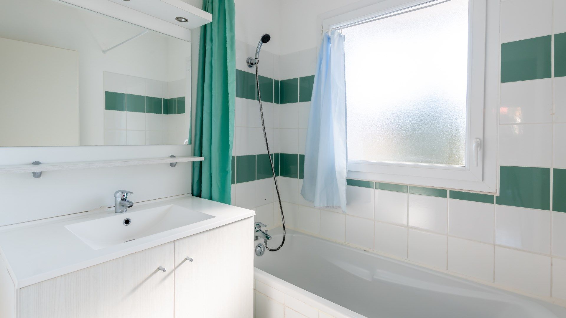 image This bathroom features a shower and tub combination.