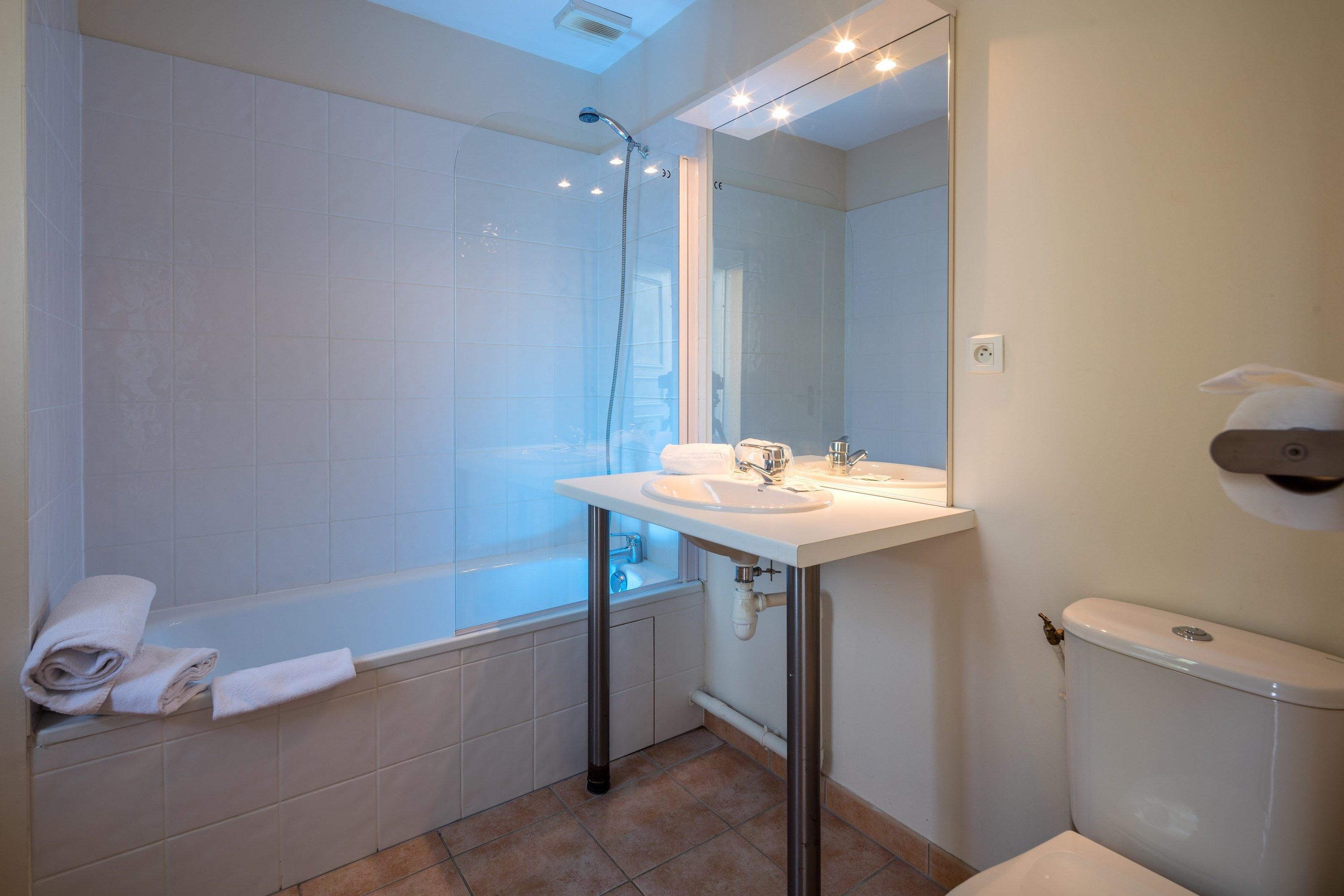 image This bathroom features a shower and tub combination.