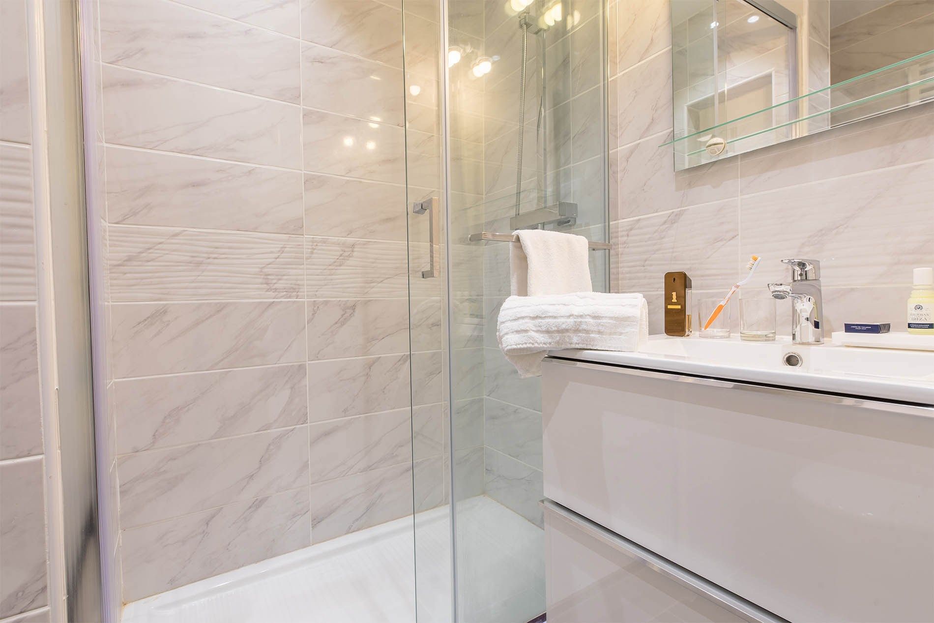 image The spacious and modern bathroom features stylish décor.