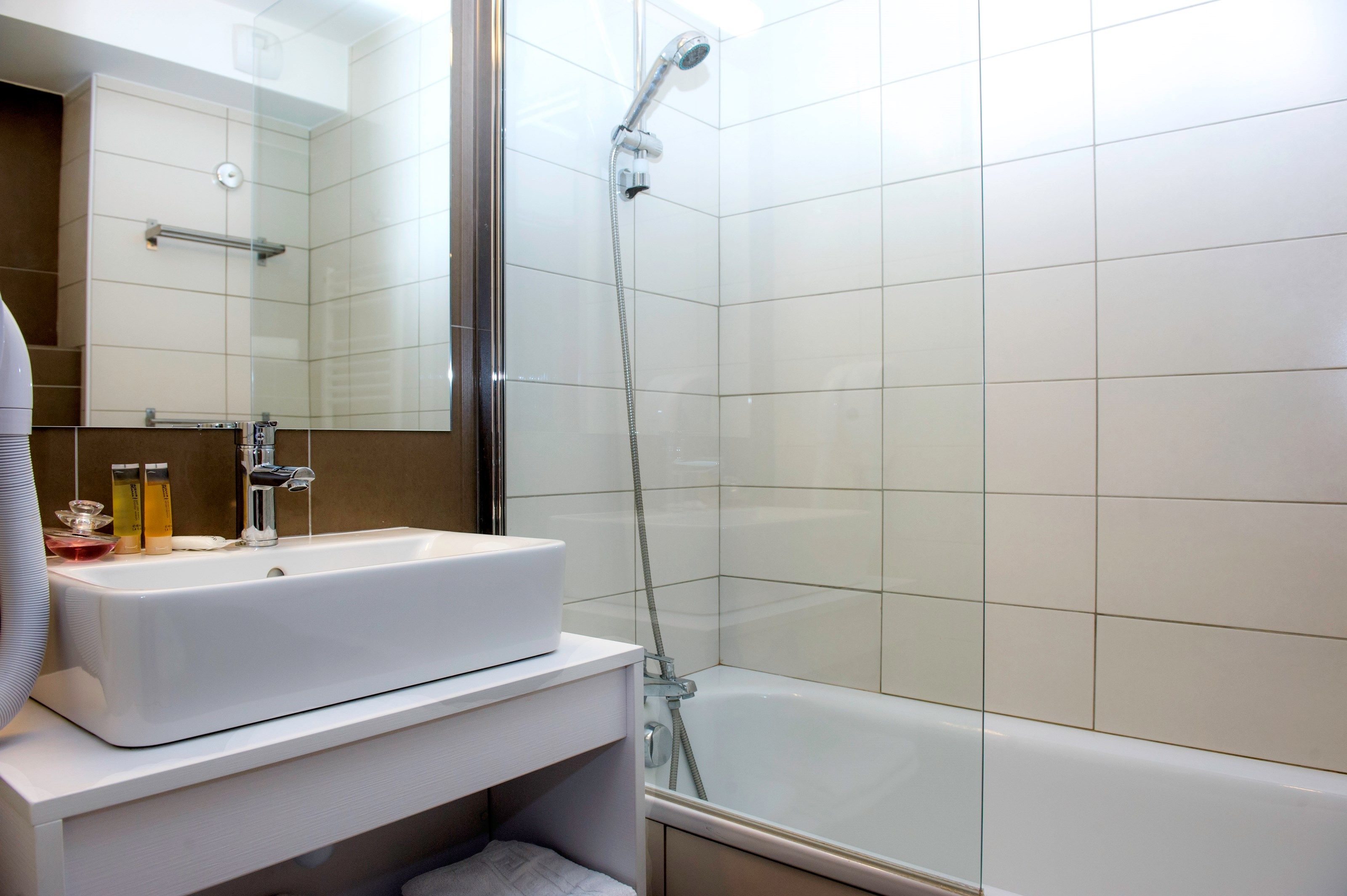 image This bathroom features a shower and tub combination.